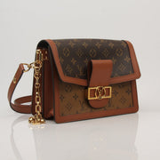 Louis Vuitton Dauphine MM handbag with gold hardware, featuring structured leather design, shown in a close-up image.