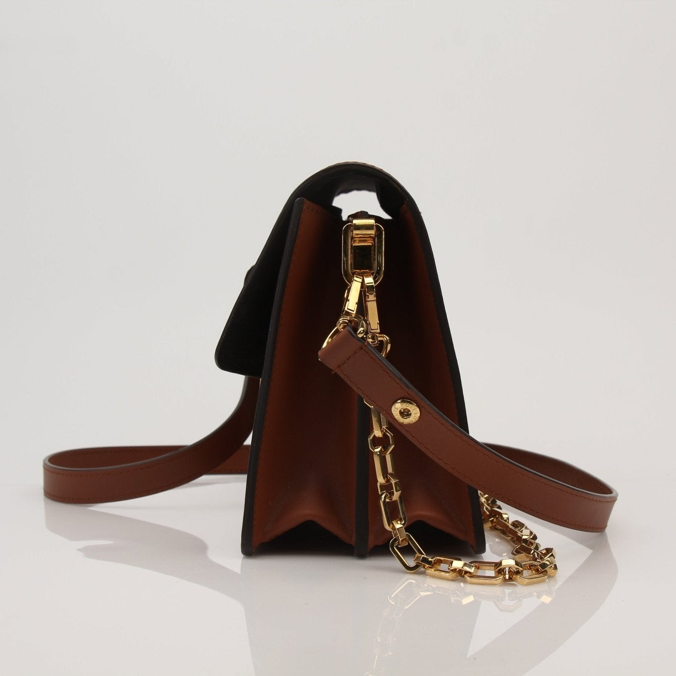 Louis Vuitton Dauphine MM handbag with gold hardware and monogram canvas, featuring top handles and a structured silhouette.