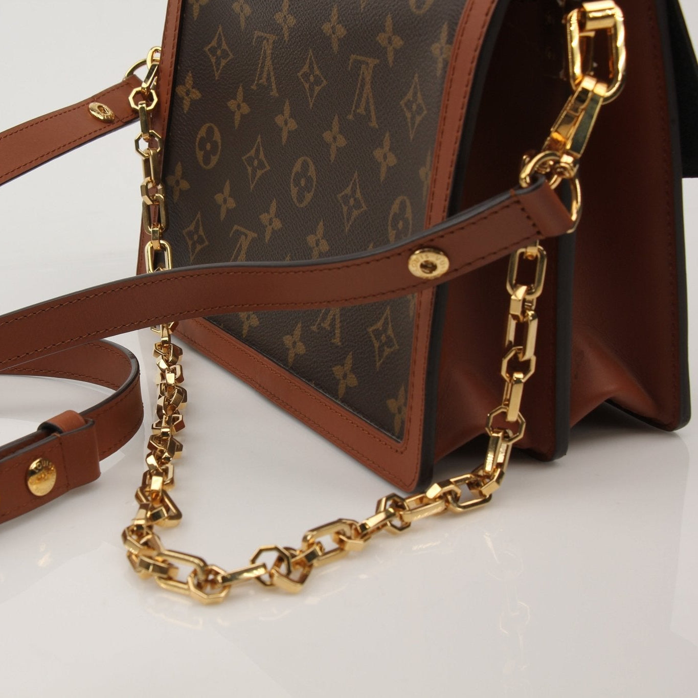 Louis Vuitton Dauphine MM handbag with gold hardware, featuring monogram canvas and structured design.