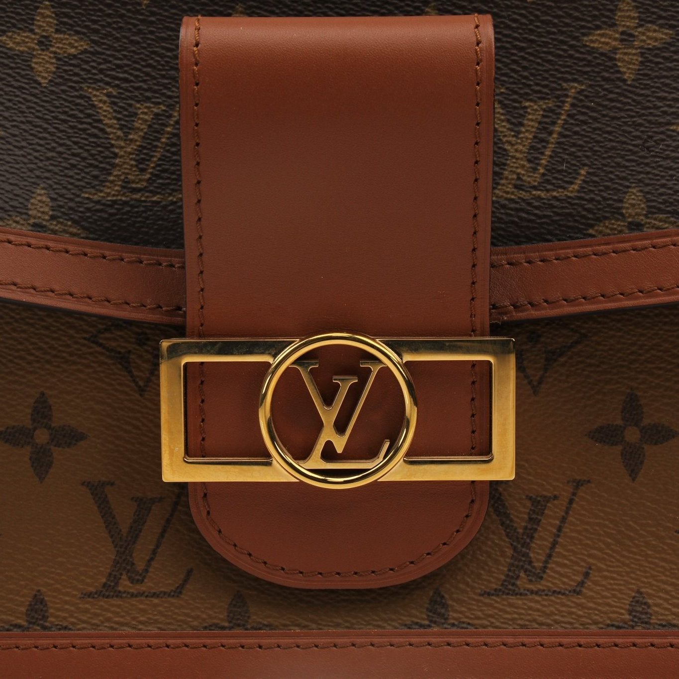 Louis Vuitton Dauphine MM handbag with gold hardware and monogram canvas, featuring structured design and top handles.