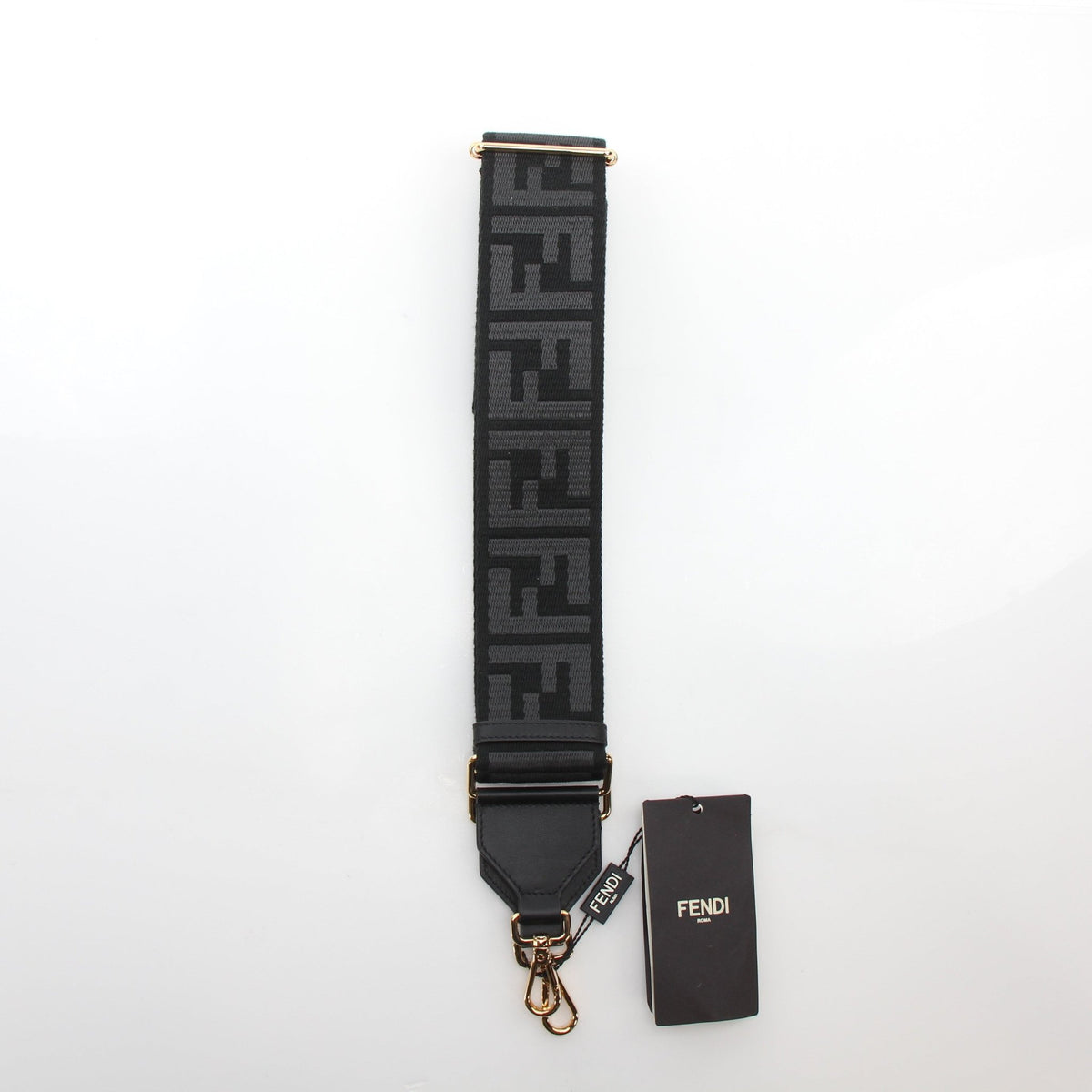 Black Fendi Strap You FF Jacquard adjustable shoulder strap with gold hardware, designed for accessories and bags.