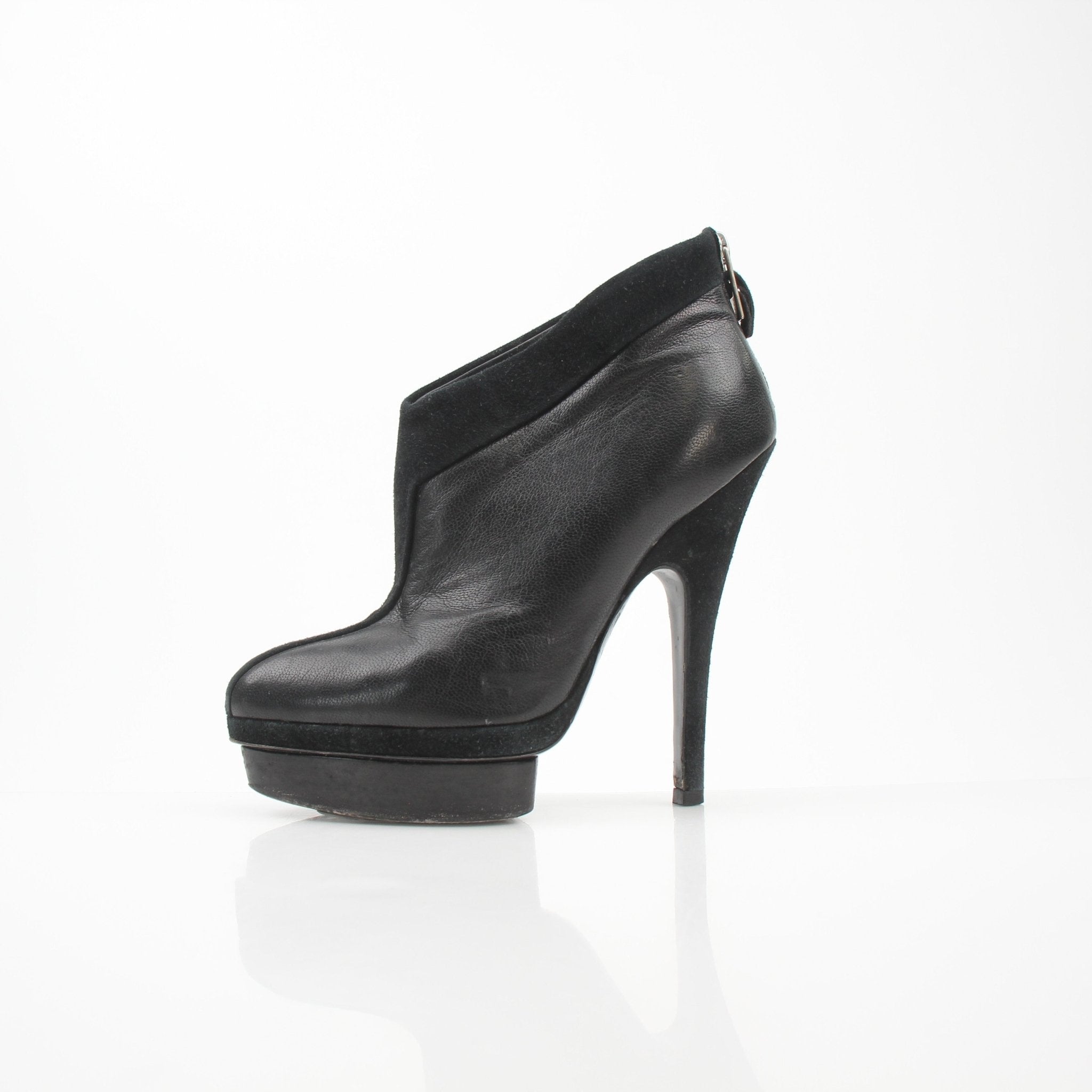 Black leather Saint Laurent Rive Gauche ankle platform pumps with high heels, showcasing sleek design and stylish shoe details.