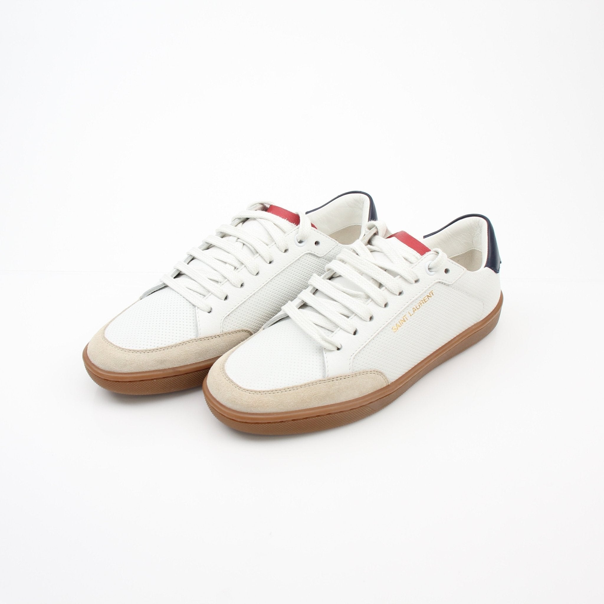 White leather Saint Laurent Court Classic SL/10 low top sneakers with gold accents, displayed on a neutral background.
