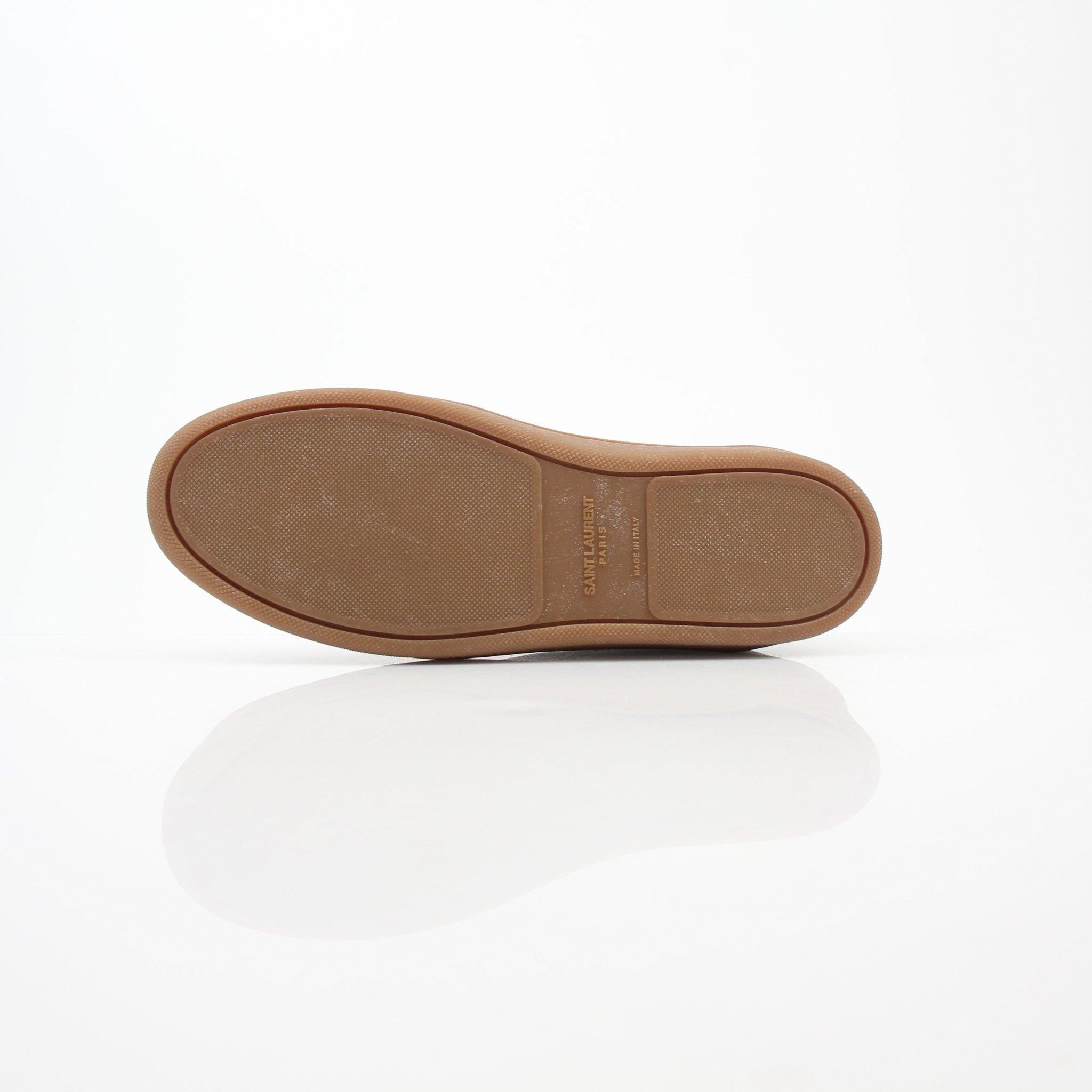 White leather Saint Laurent Court Classic SL/10 sneakers with low-top design, featuring gold accents and stylish branding.