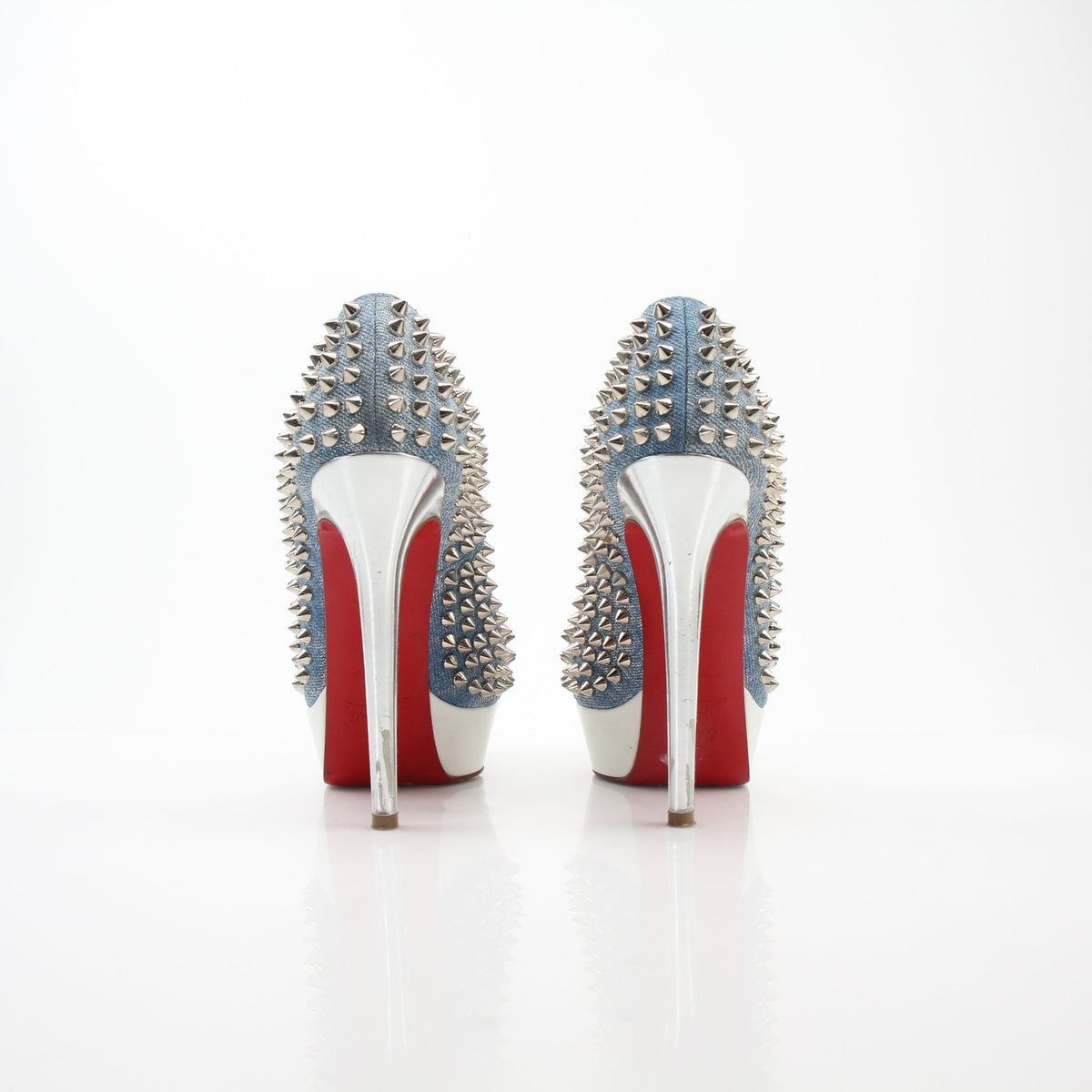 Christian Louboutin Bianca spiked denim platform heels with pointed toe and stiletto heel, featuring signature red sole and metallic spikes.