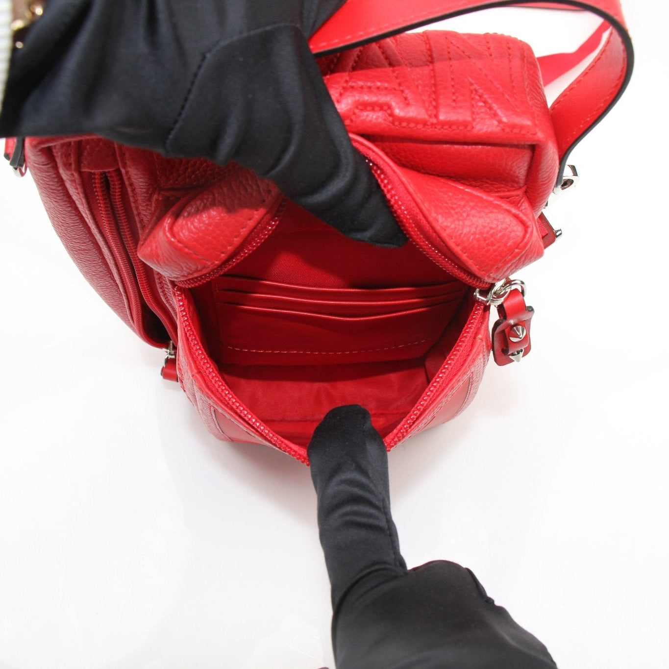 Christian Louboutin Loubideal crossbody handbag with gold accents, featuring sleek design and signature style, shown in the image.