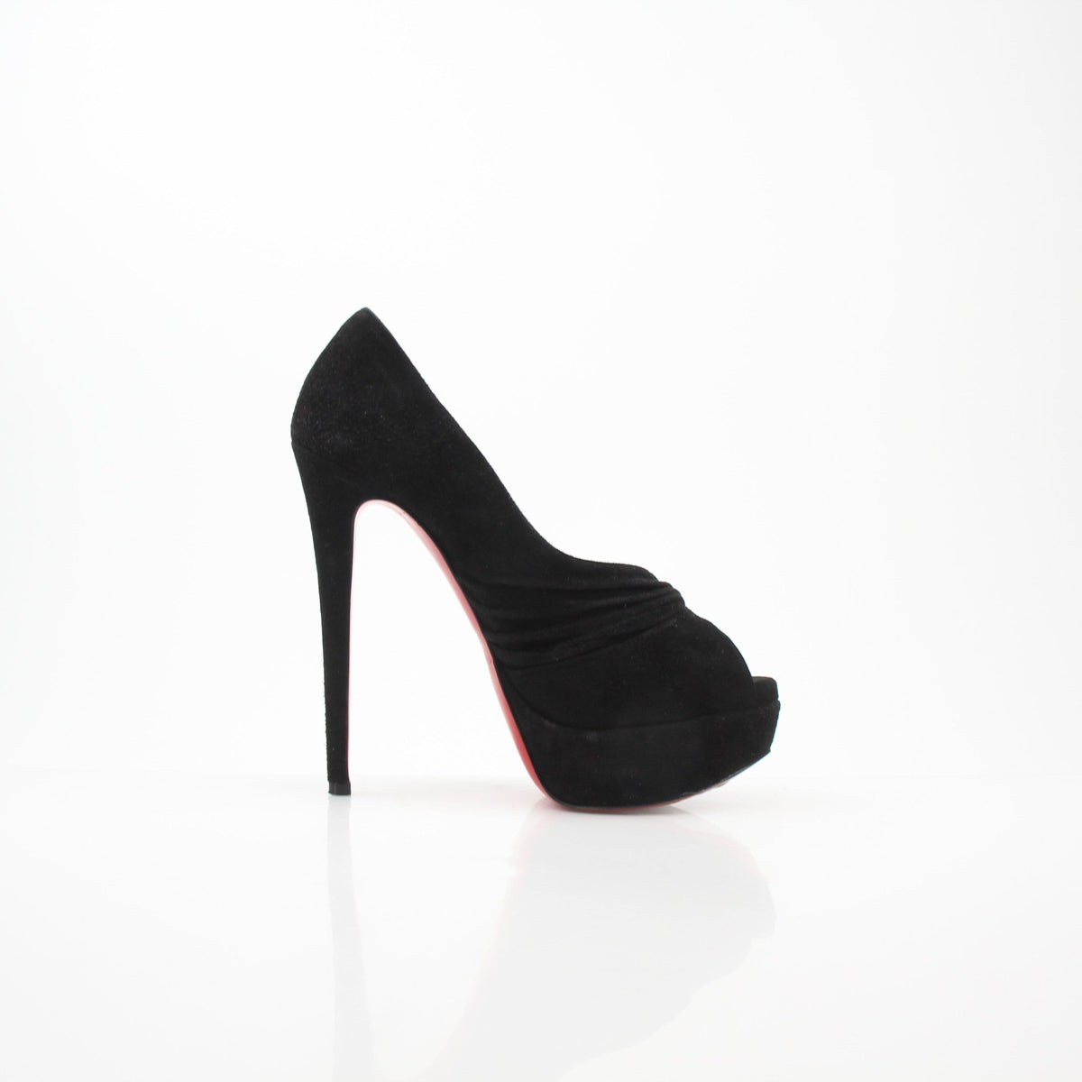 Black suede Christian Louboutin Drapadita platform heels with stiletto design and signature red sole, photographed from the side.
