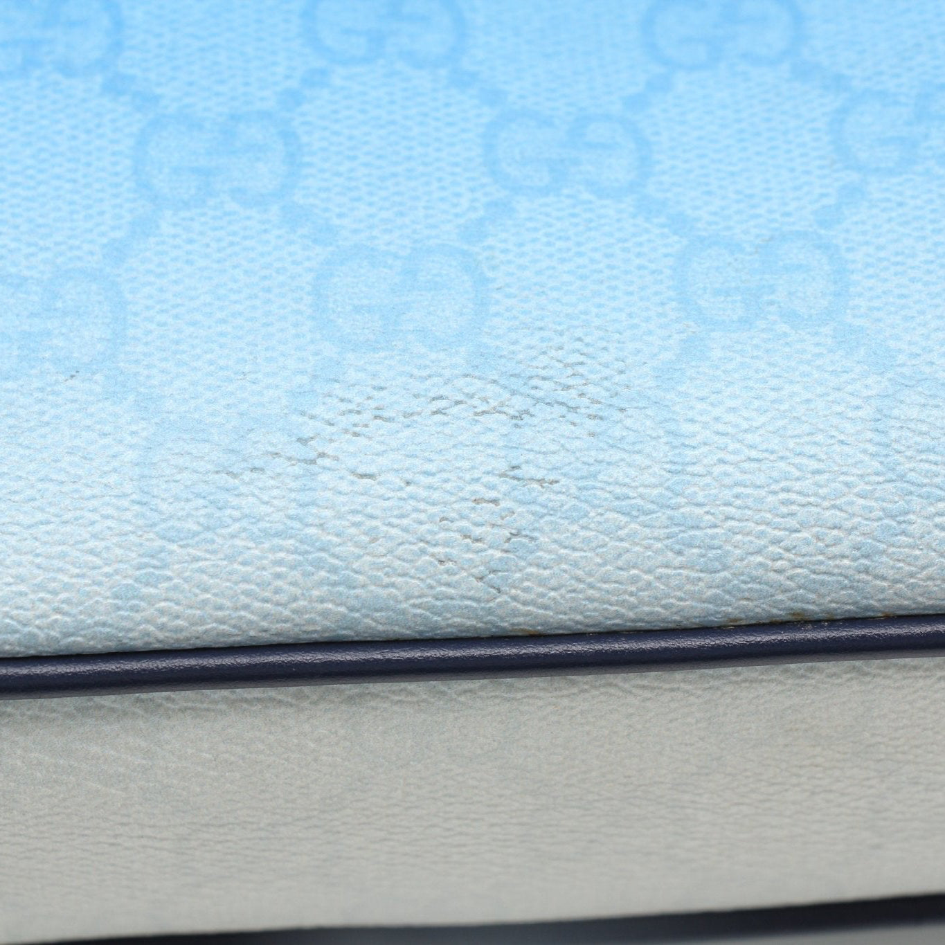 Blue gradient Gucci GG crossbody handbag with gold accents, showcasing a stylish and compact designer handbag.