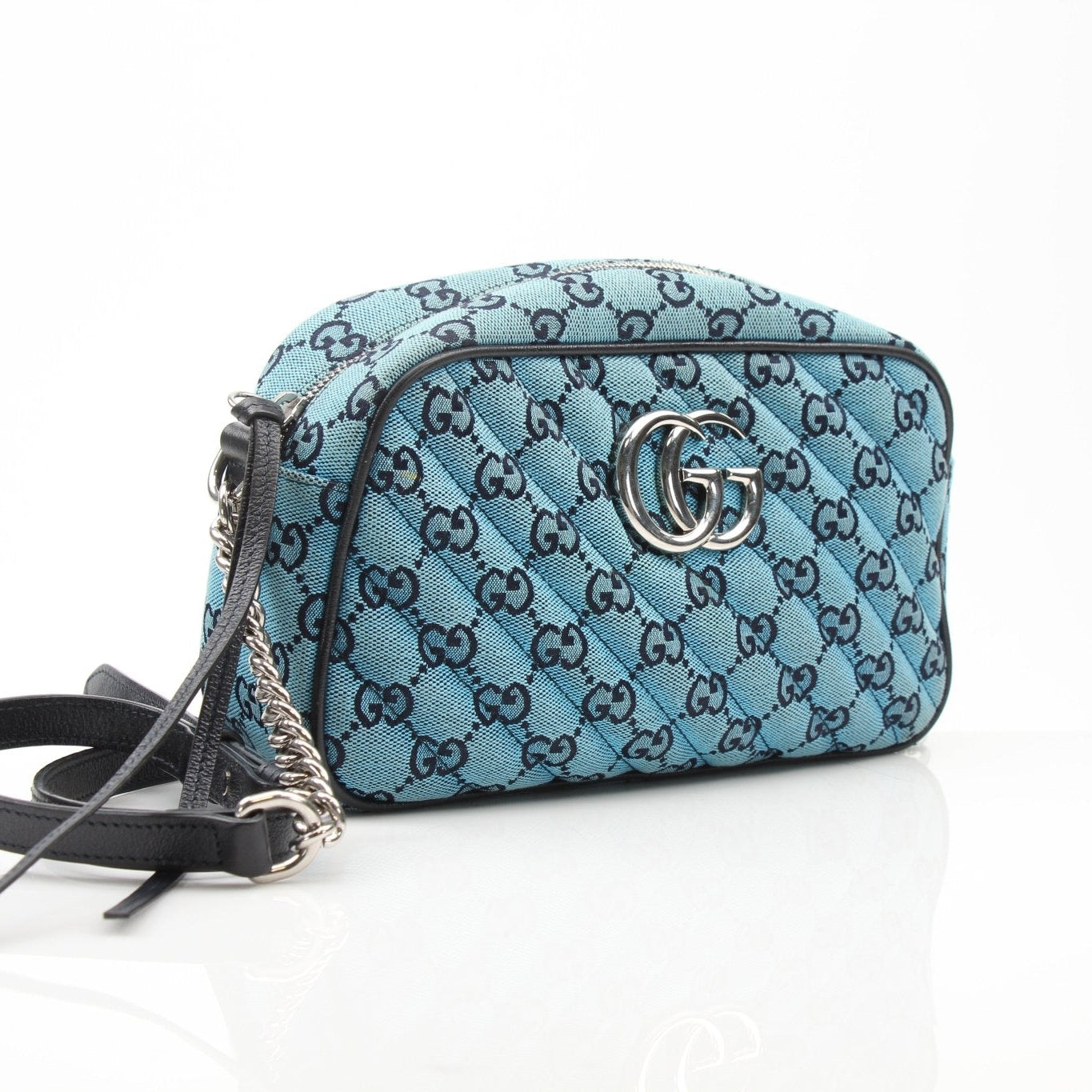 Gold & Beyond Gucci GG Marmont camera handbag with quilted leather and gold chain strap, stylish and compact accessory.