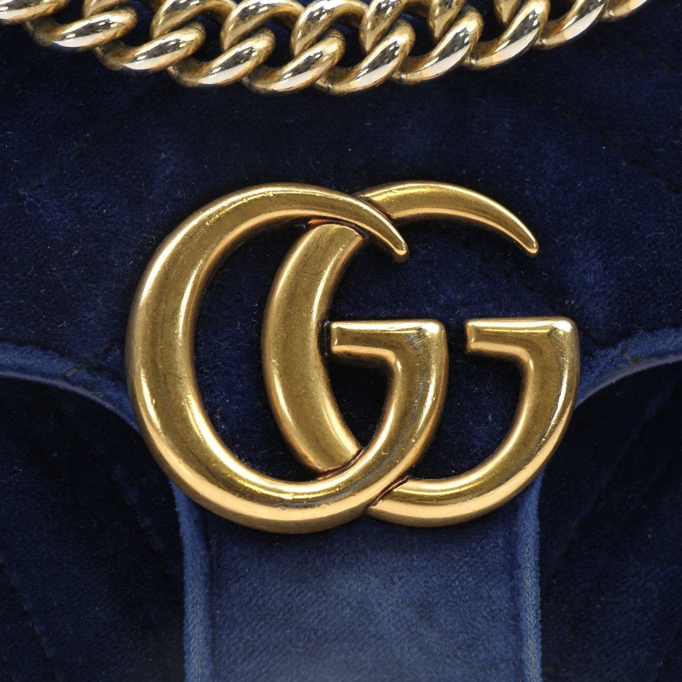 Gold & Beyond Gucci GG Marmont Mini Handbag with quilted leather and gold-tone hardware, showcasing a chic, compact design.