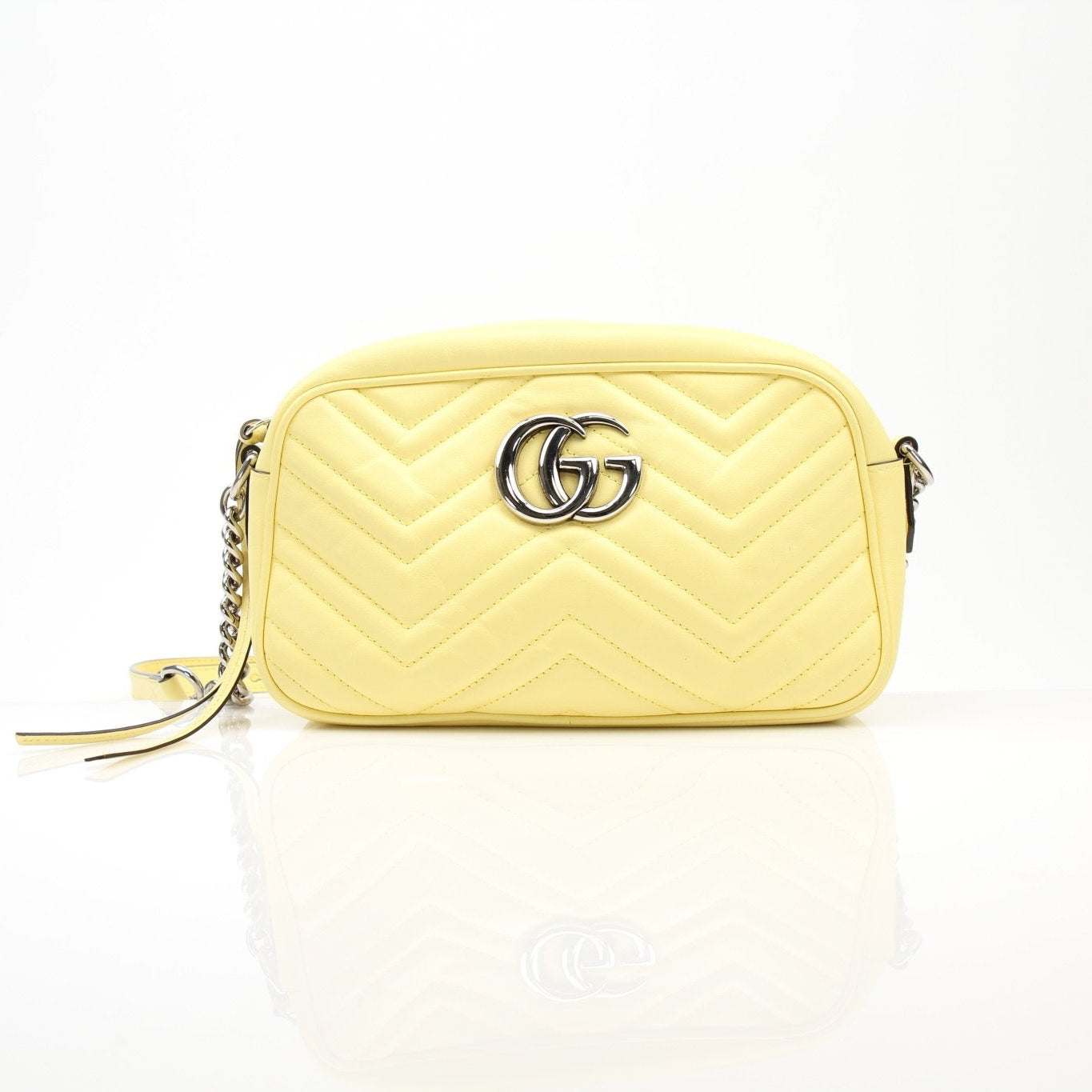 Gucci GG Marmont shoulder handbag with quilted leather and gold hardware, featuring a chain strap and chevron pattern.