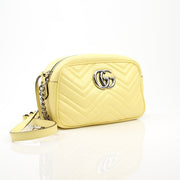 Gucci GG Marmont shoulder handbag with quilted leather and chain strap, featuring the signature double G logo in gold.