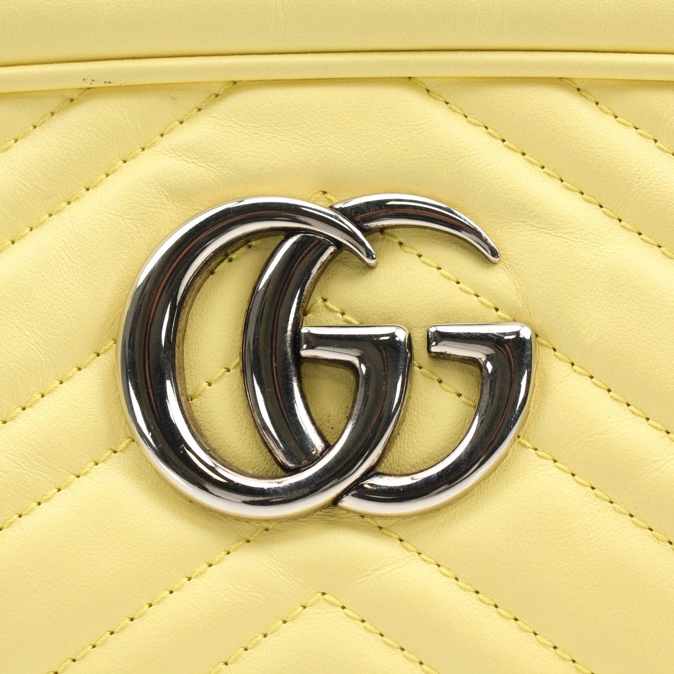 Gold & Beyond Gucci GG Marmont shoulder handbag with chevron quilted leather and gold-tone hardware, featuring a chain strap.