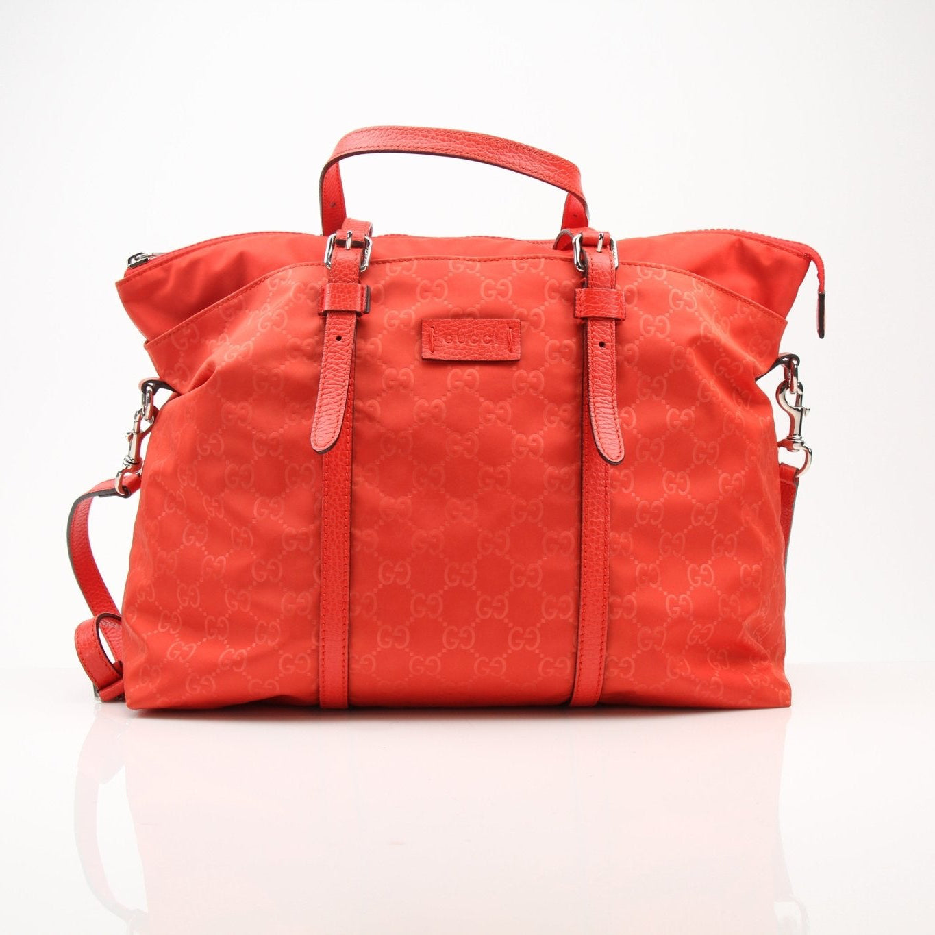 Gucci GG nylon tote bag, stylish travel bag with logo pattern, featuring sturdy handles and spacious interior for travel essentials.