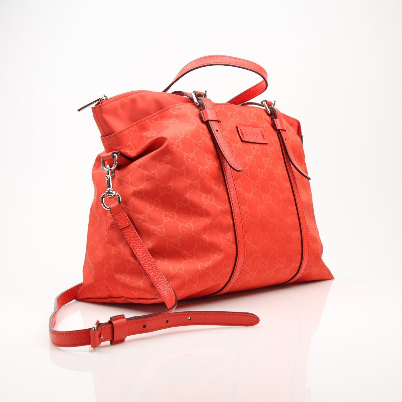 Gucci GG nylon tote bag for travel, featuring the iconic logo, sturdy handles, and spacious interior for everyday use.