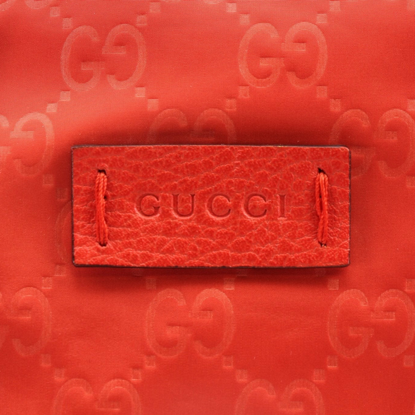 Gucci GG nylon tote bag for travel, shown in black with leather handles and spacious interior, designed for stylish travel organization.