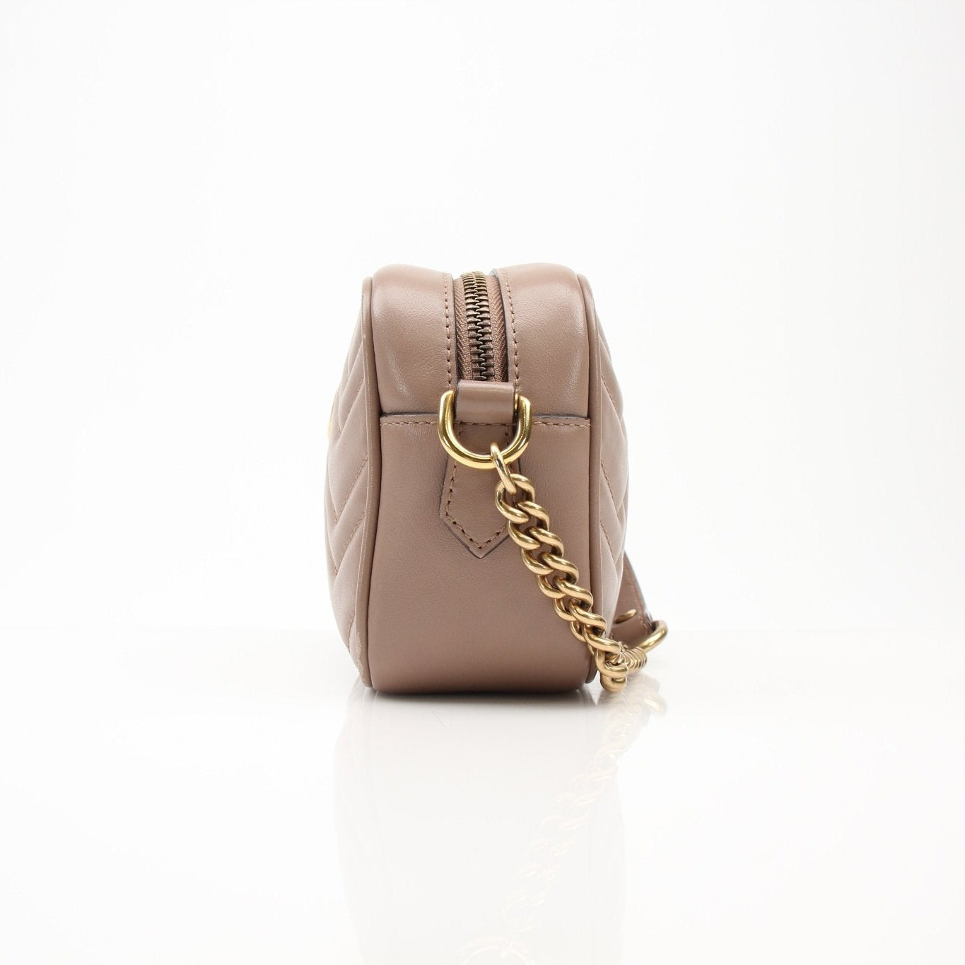 Gucci Mini GG Marmont mini camera handbag with quilted leather and gold chain strap, designed by Gold & Beyond.