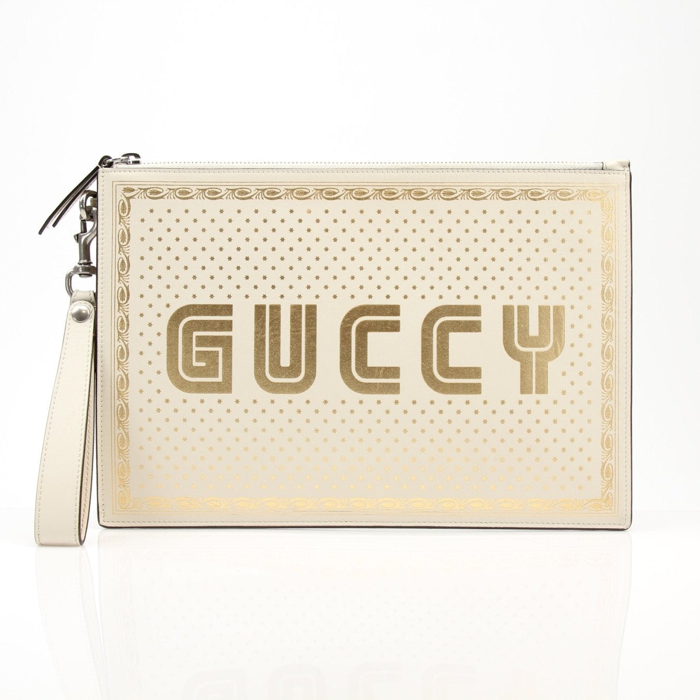 Cream leather Gucci Moon and Stars zip-around pouch with celestial print, featuring gold-tone accents and compact handbag design.