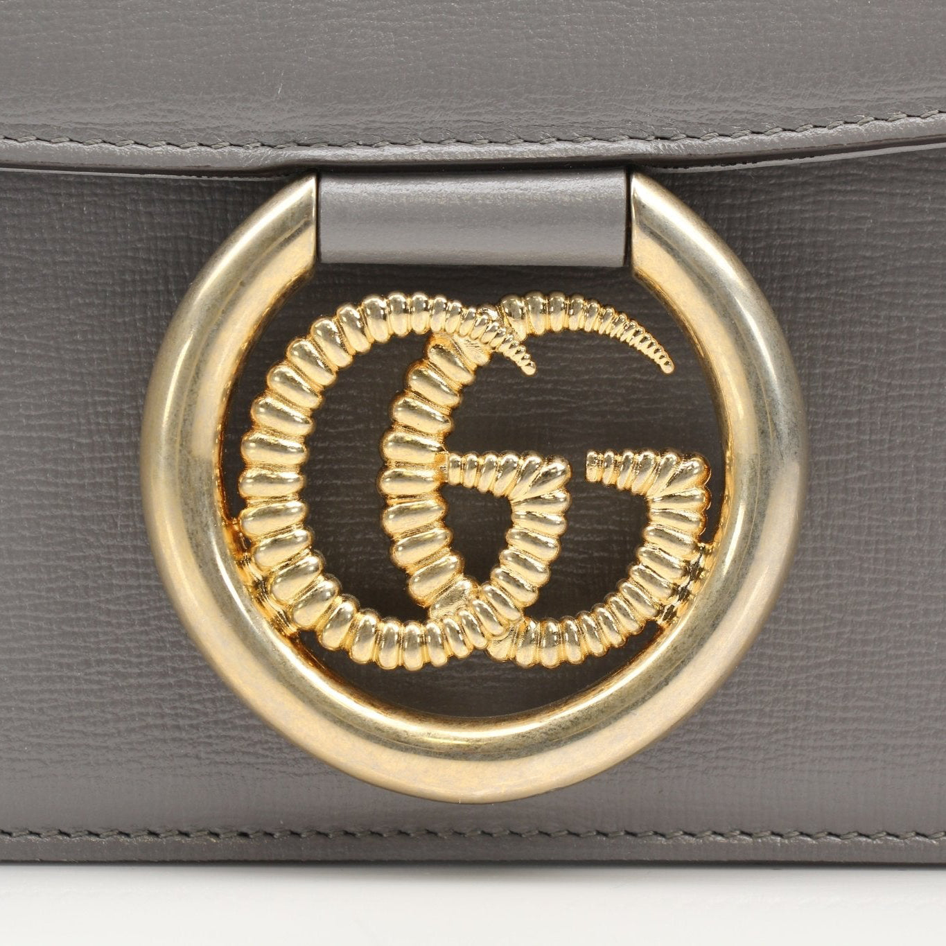 Gucci GG Marmont shoulder handbag in black leather with gold hardware, featuring chevron quilting and chain strap.