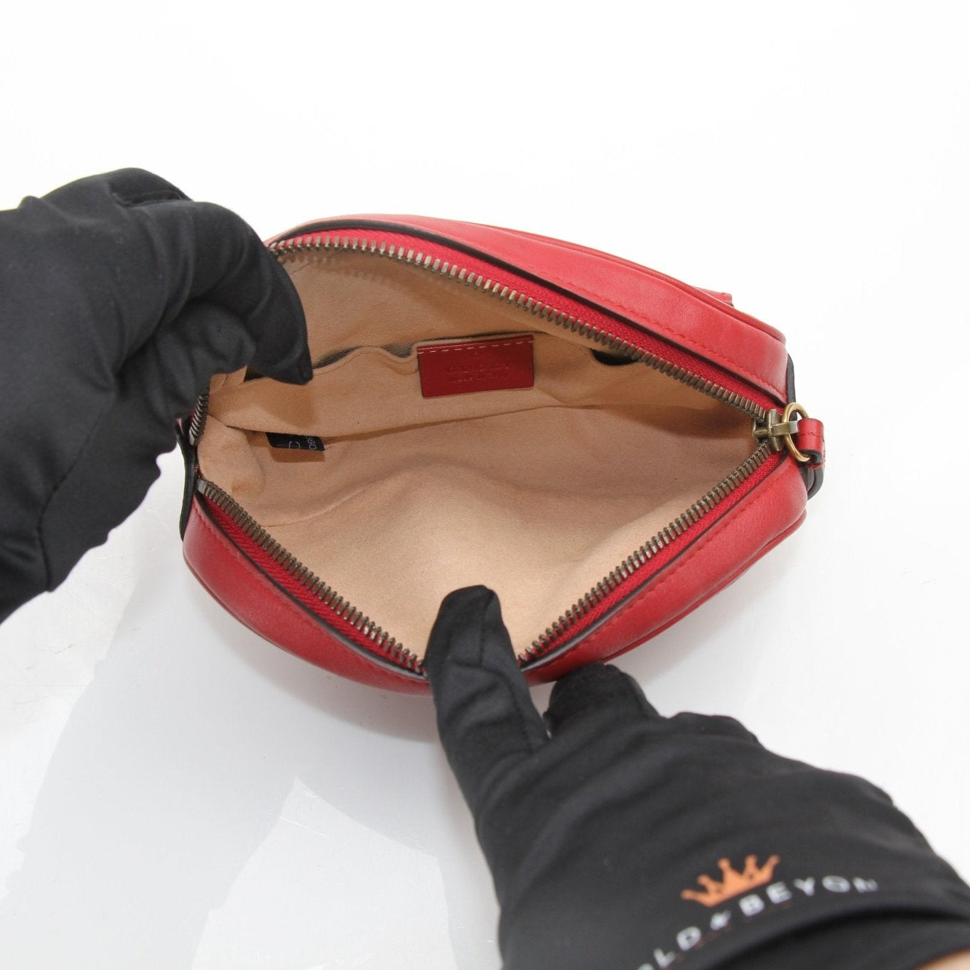 Gucci GG Marmont belt bag, stylish handbag with quilted leather and gold hardware, on a neutral background.