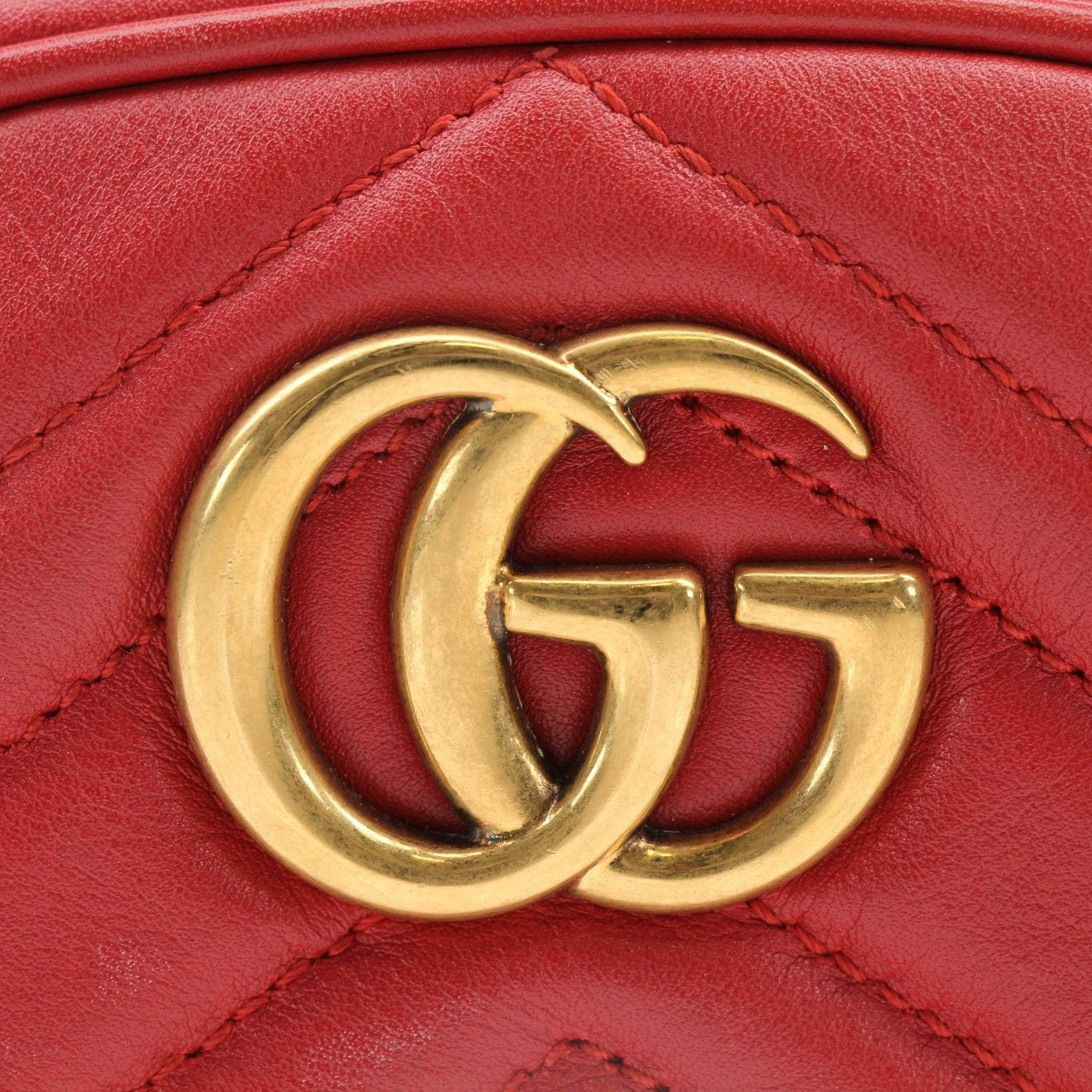 Gold & Beyond Gucci GG Marmont belt bag handbag with quilted leather and gold hardware, stylishly displayed.