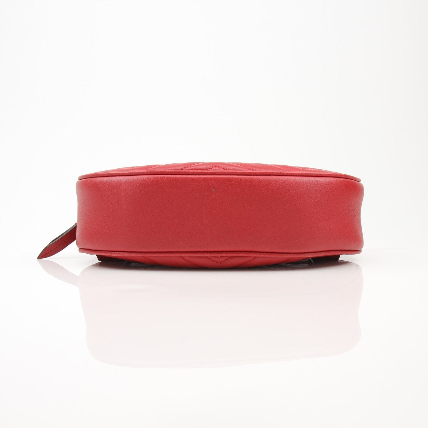 Gold & Beyond Gucci GG Marmont belt bag handbag with quilted leather and gold hardware, shown in a close-up image.