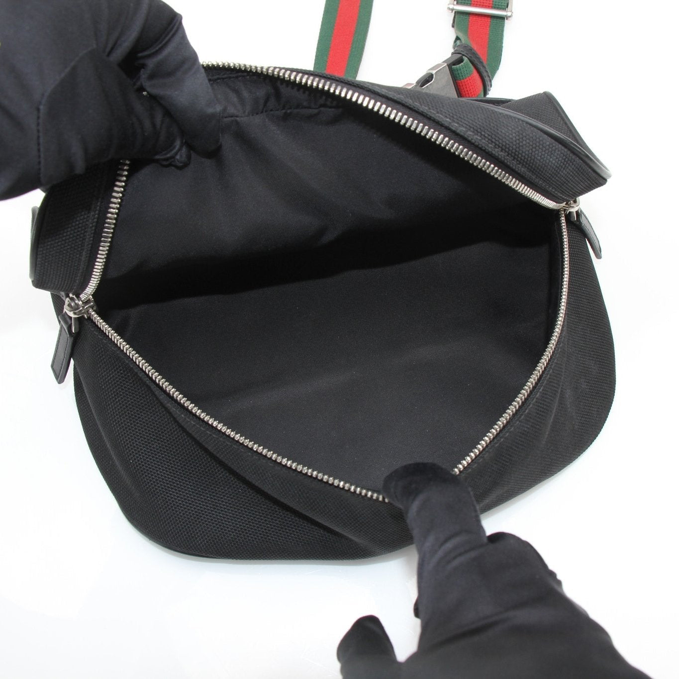 Gucci Techno Web Canvas waist bag, versatile handbag with adjustable strap and logo details, on a neutral background.