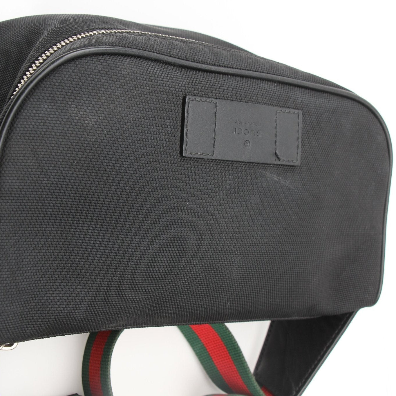 Gucci Techno Web Canvas waist bag, stylish handbag with adjustable strap and Gucci logo, on a plain background