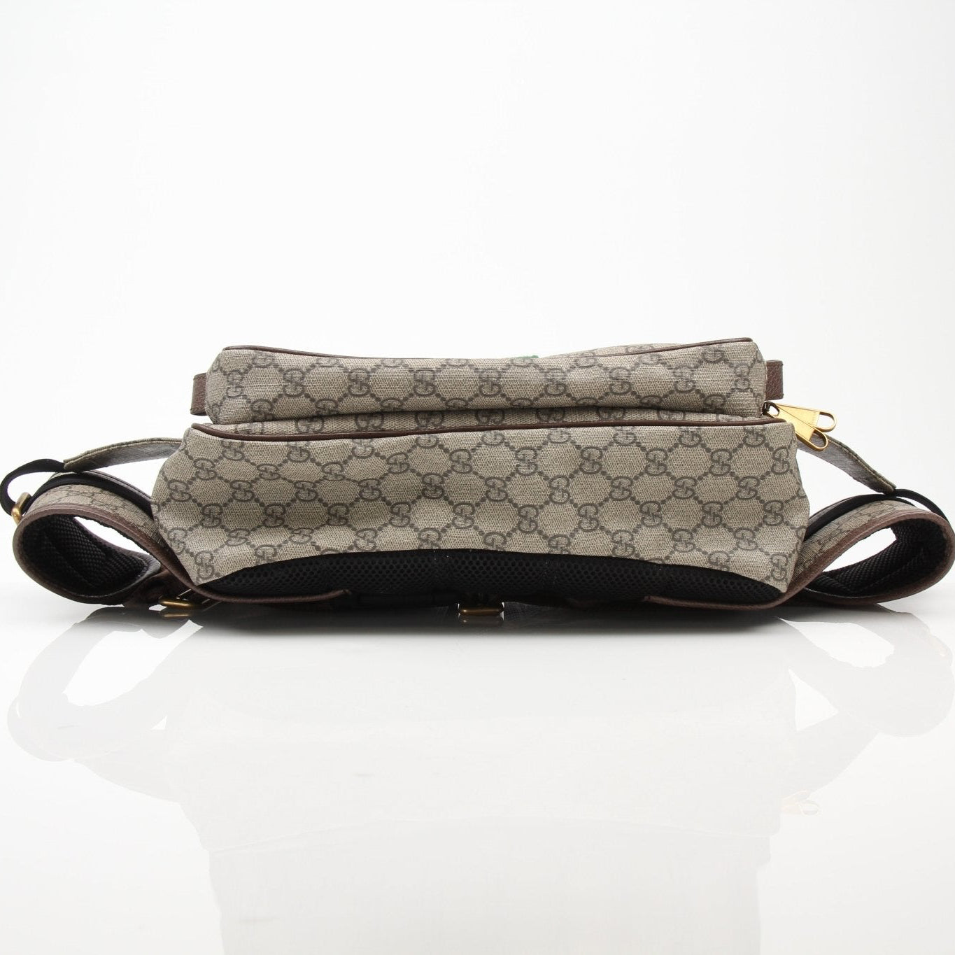 Gucci GG Ophidia belt bag with signature monogram pattern and gold-tone hardware, worn as a stylish handbag accessory.
