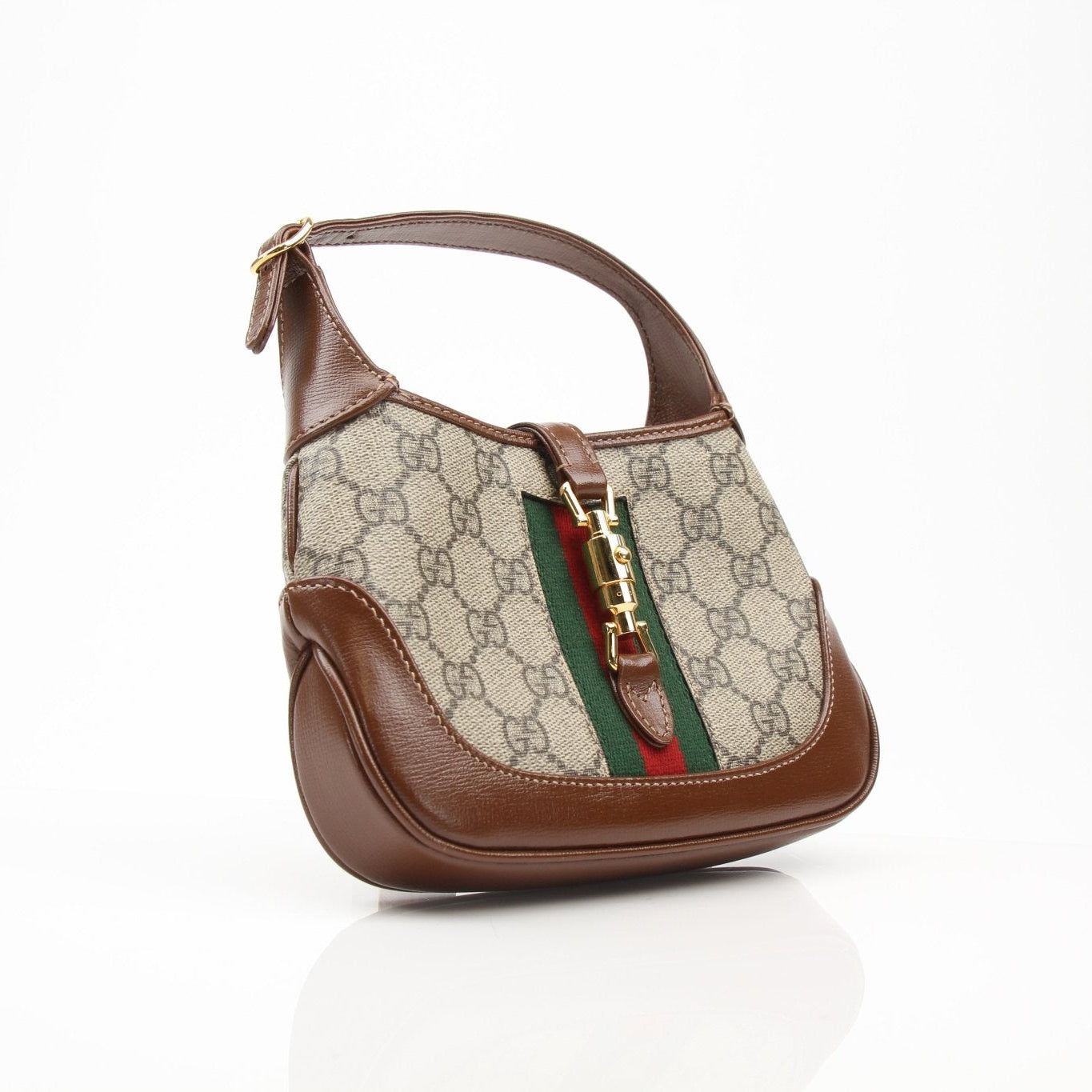 Gucci 1961 Mini Jackie GG shoulder handbag in beige with gold hardware, featuring a signature monogram pattern and top handle.