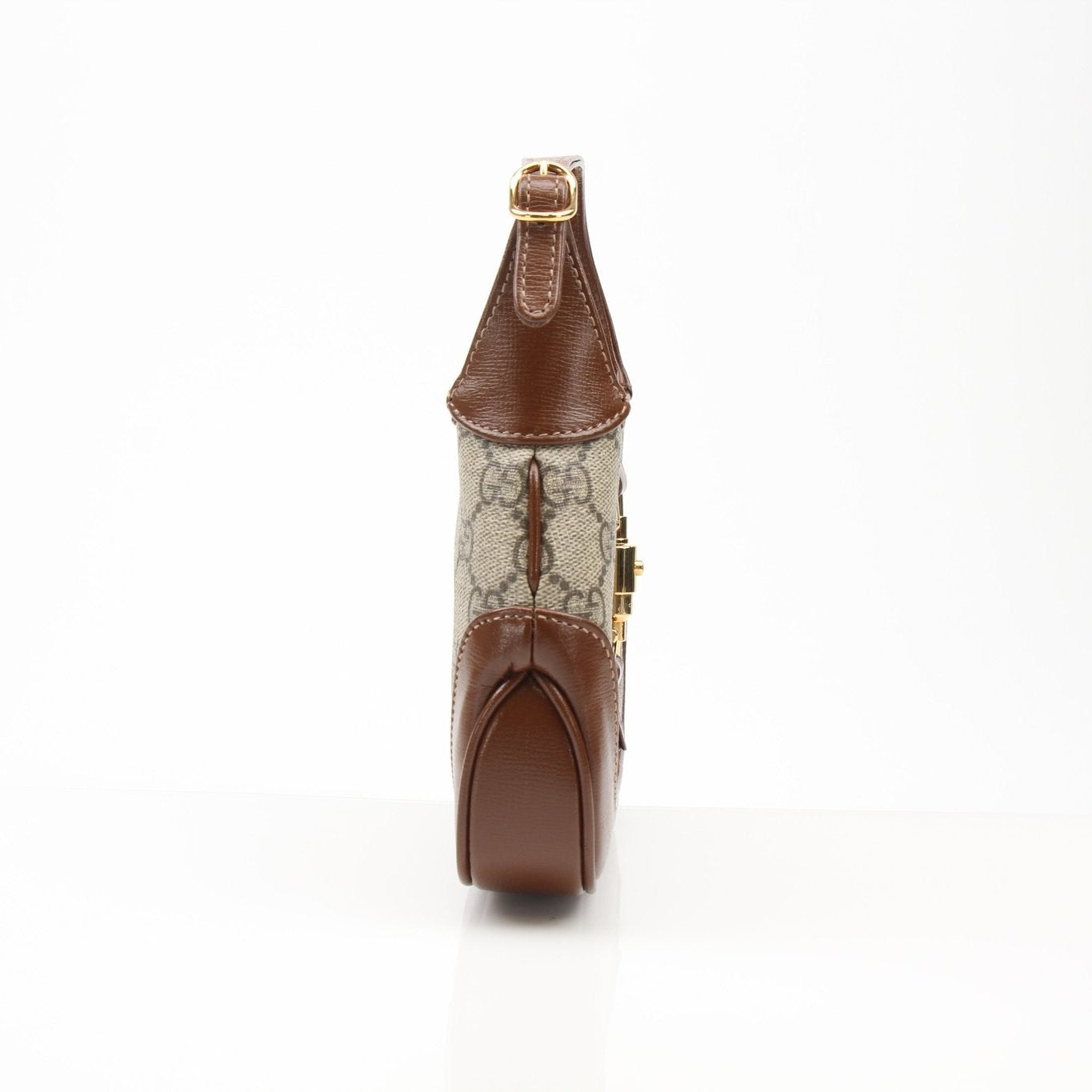 Gucci 1961 Mini Jackie GG shoulder handbag in beige with gold hardware, featuring the signature GG pattern and structured design.