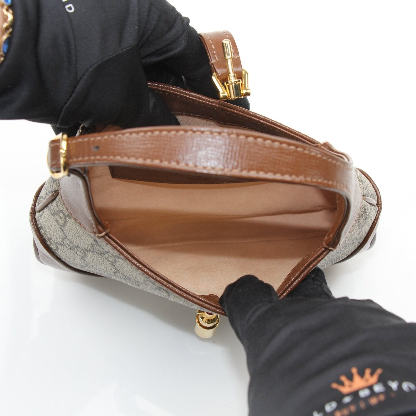 Gucci 1961 Mini Jackie GG shoulder handbag in beige and brown leather with gold hardware, detailed stitching, and iconic design.