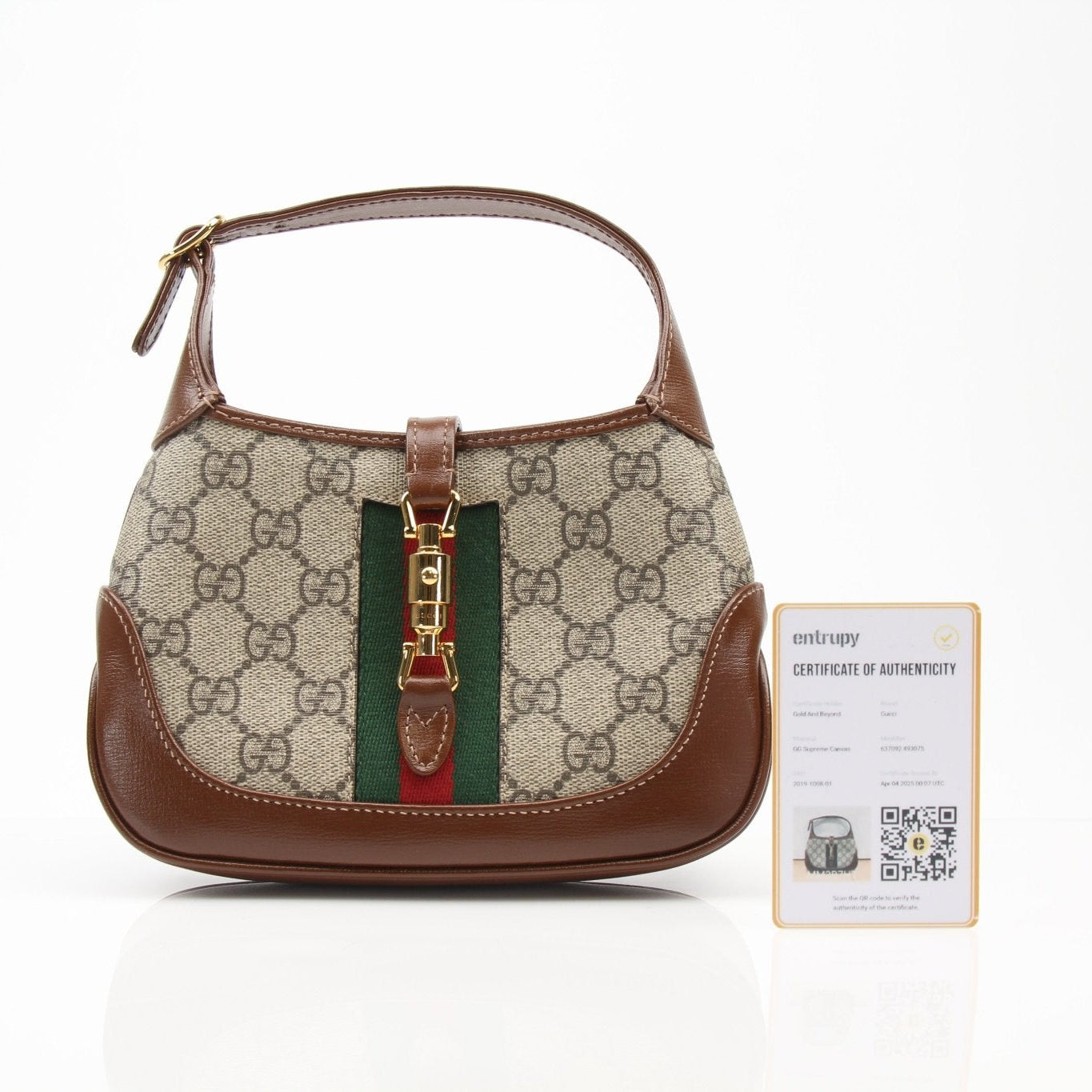 Gucci 1961 Mini Jackie GG shoulder handbag in beige and brown with gold hardware and adjustable strap.