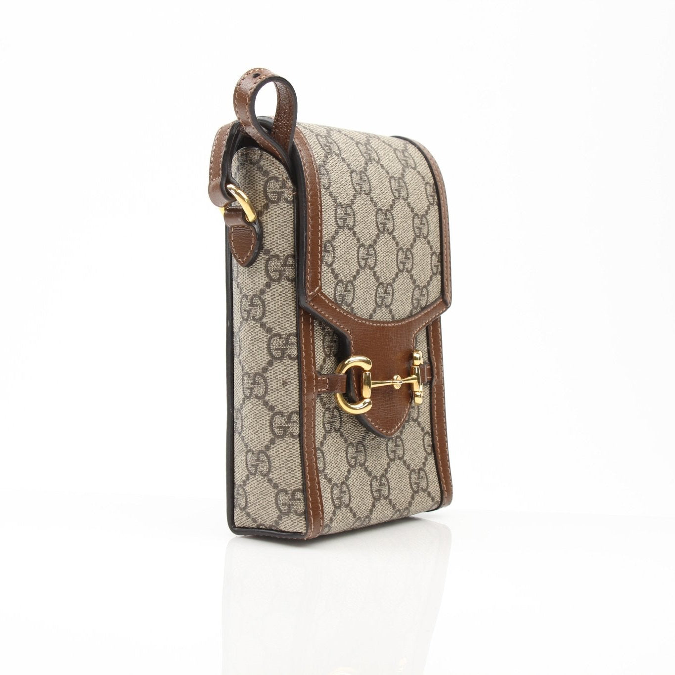 Gold & Beyond Gucci GG Supreme Horsebit mini crossbody handbag with leather strap and signature design on beige canvas.