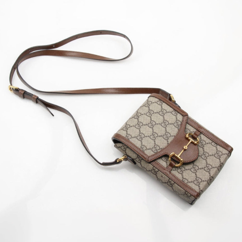 Gold & Beyond Gucci GG Supreme Horsebit Mini Crossbody Handbag showing textured fabric and gold-tone horsebit detail.