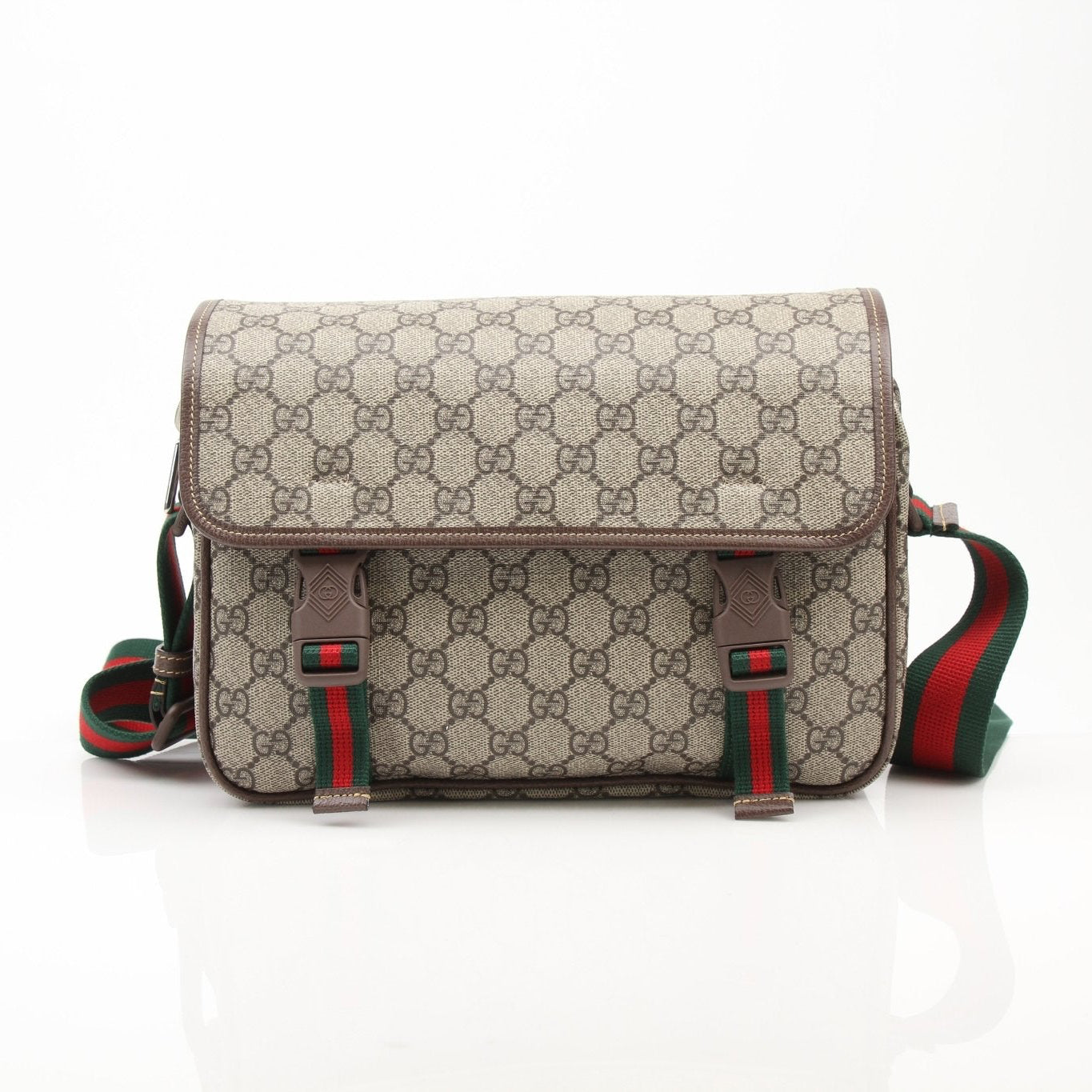 Gold & Beyond Gucci GG Supreme messenger handbag with adjustable strap and branded logo, styled for casual or formal wear.