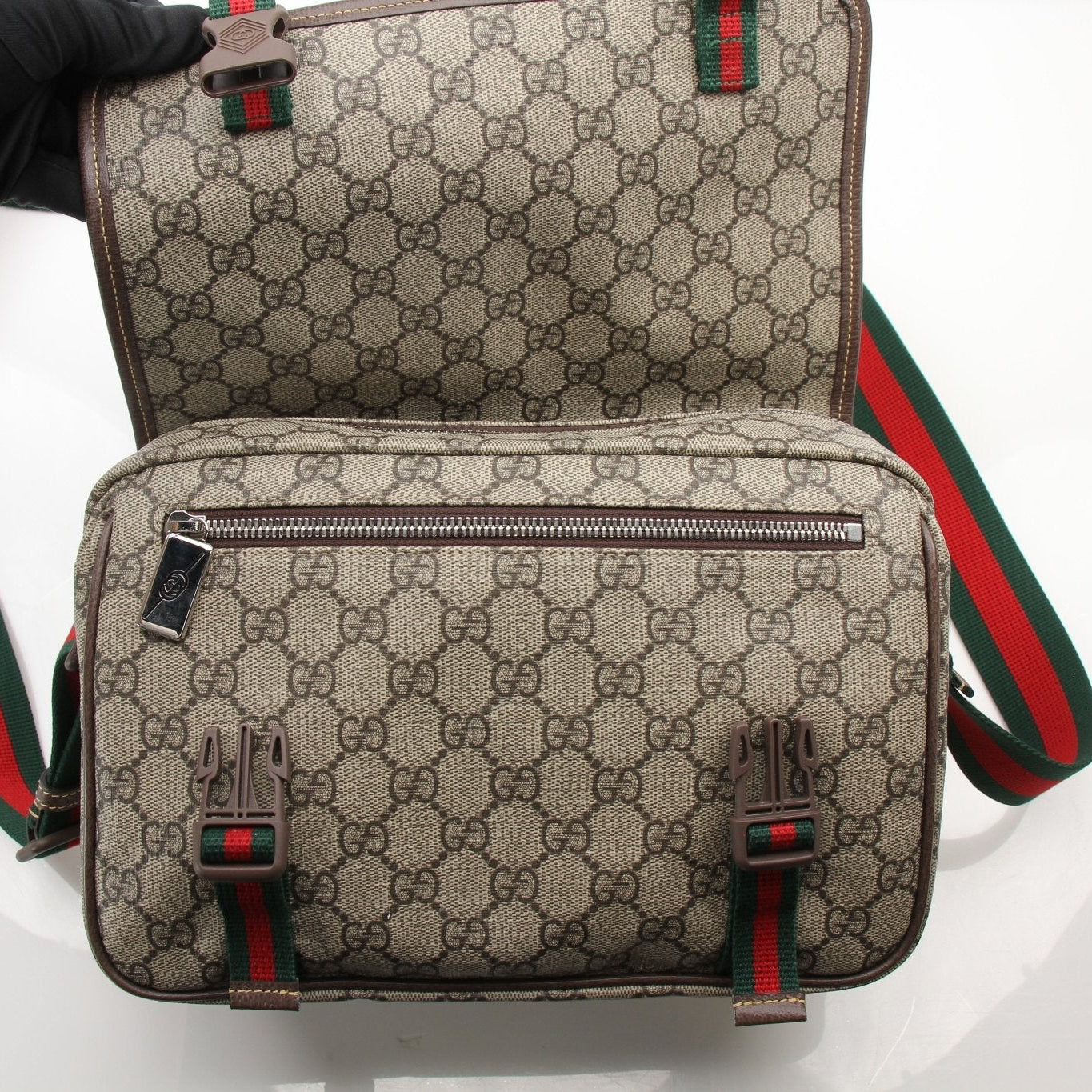 Gold & Beyond Gucci GG Supreme messenger handbag with adjustable strap and signature monogram pattern, stylish and functional.
