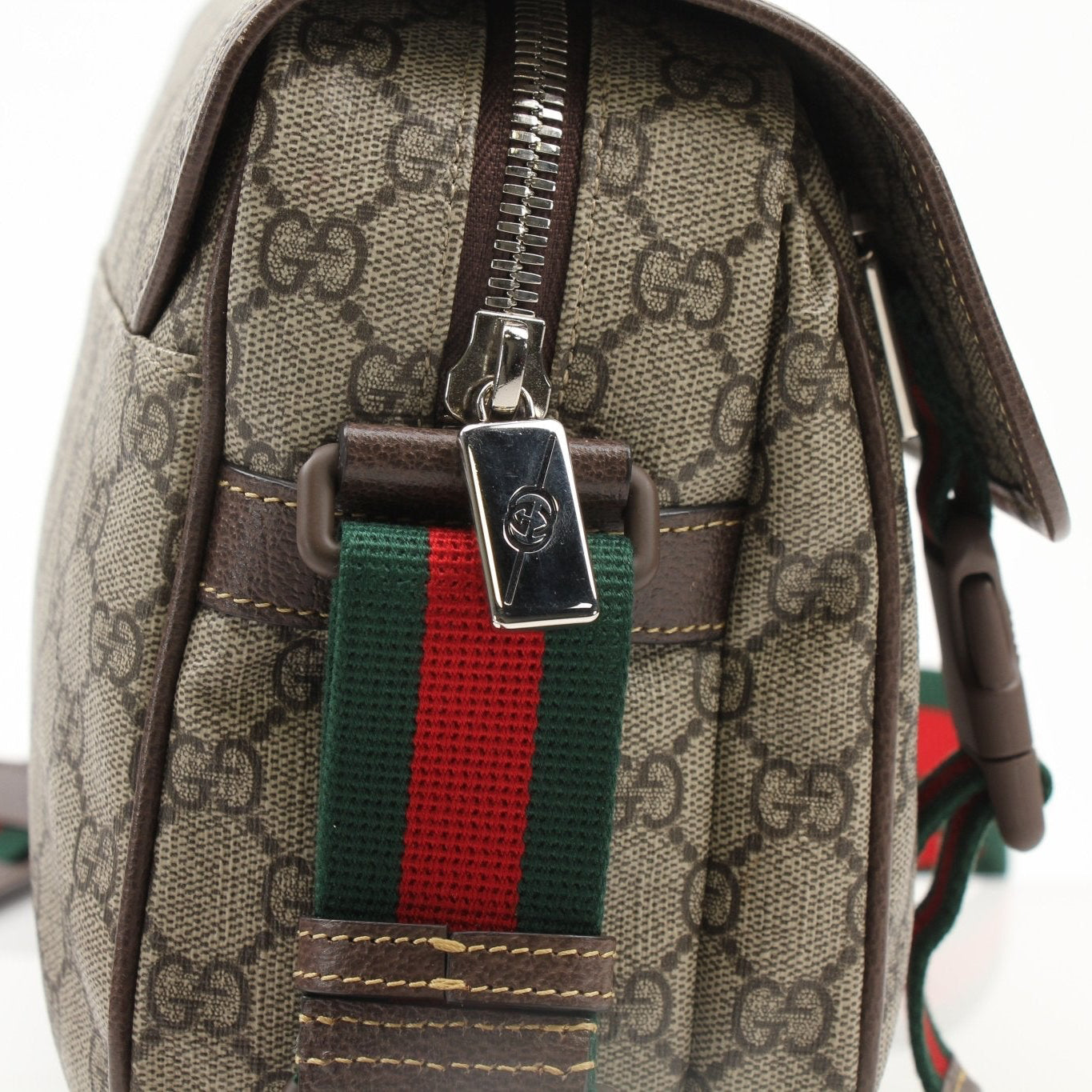 Gold & Beyond Gucci GG Supreme messenger handbag with adjustable strap and signature pattern, featuring leather accents.