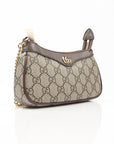 Gucci Ophidia GG Supreme Canvas handbag featuring the iconic GG pattern and a stylish design in a chic setting.