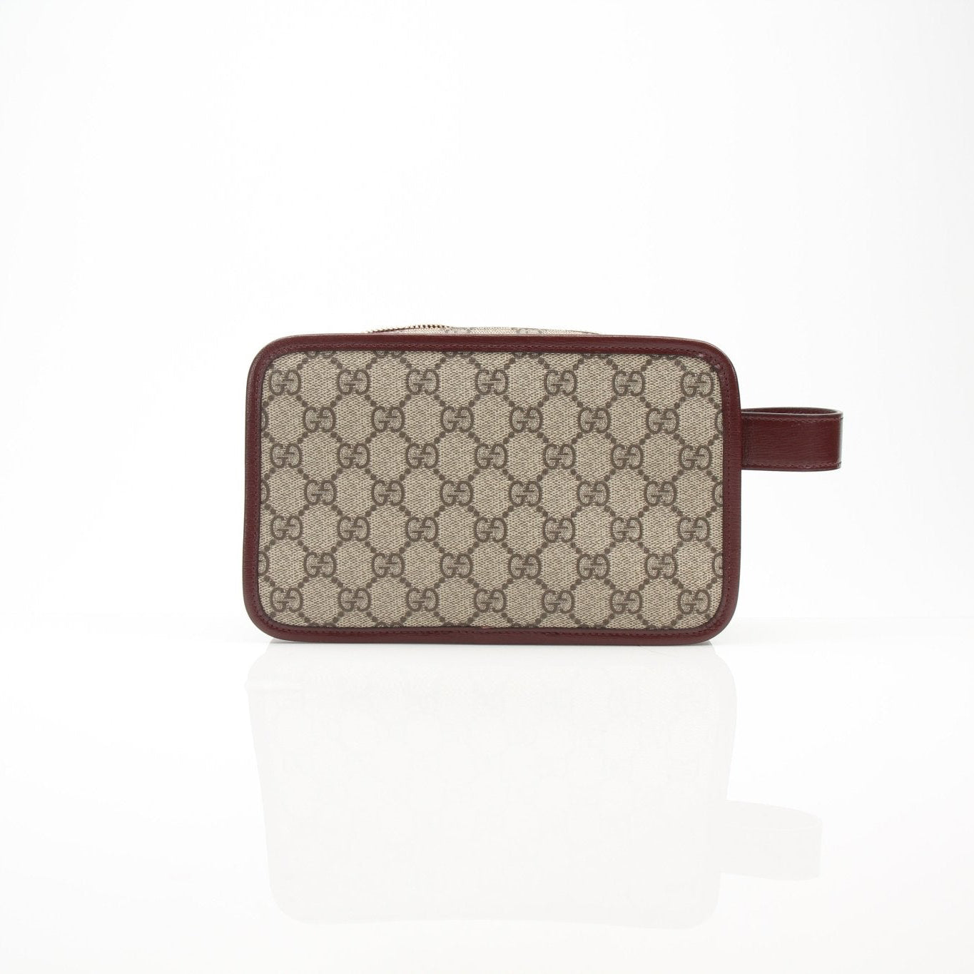 Gold & Beyond Gucci GG Supreme Dopp Kit pouch for travel, featuring signature monogram canvas and leather accents.