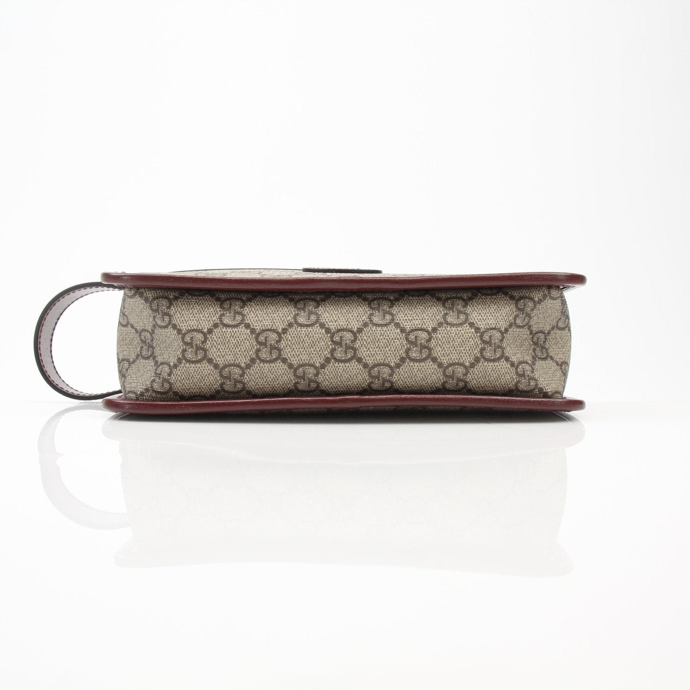 Gucci GG Supreme Dopp Kit pouch for travel bags, showing the stylish fabric and compact design with gold accents.
