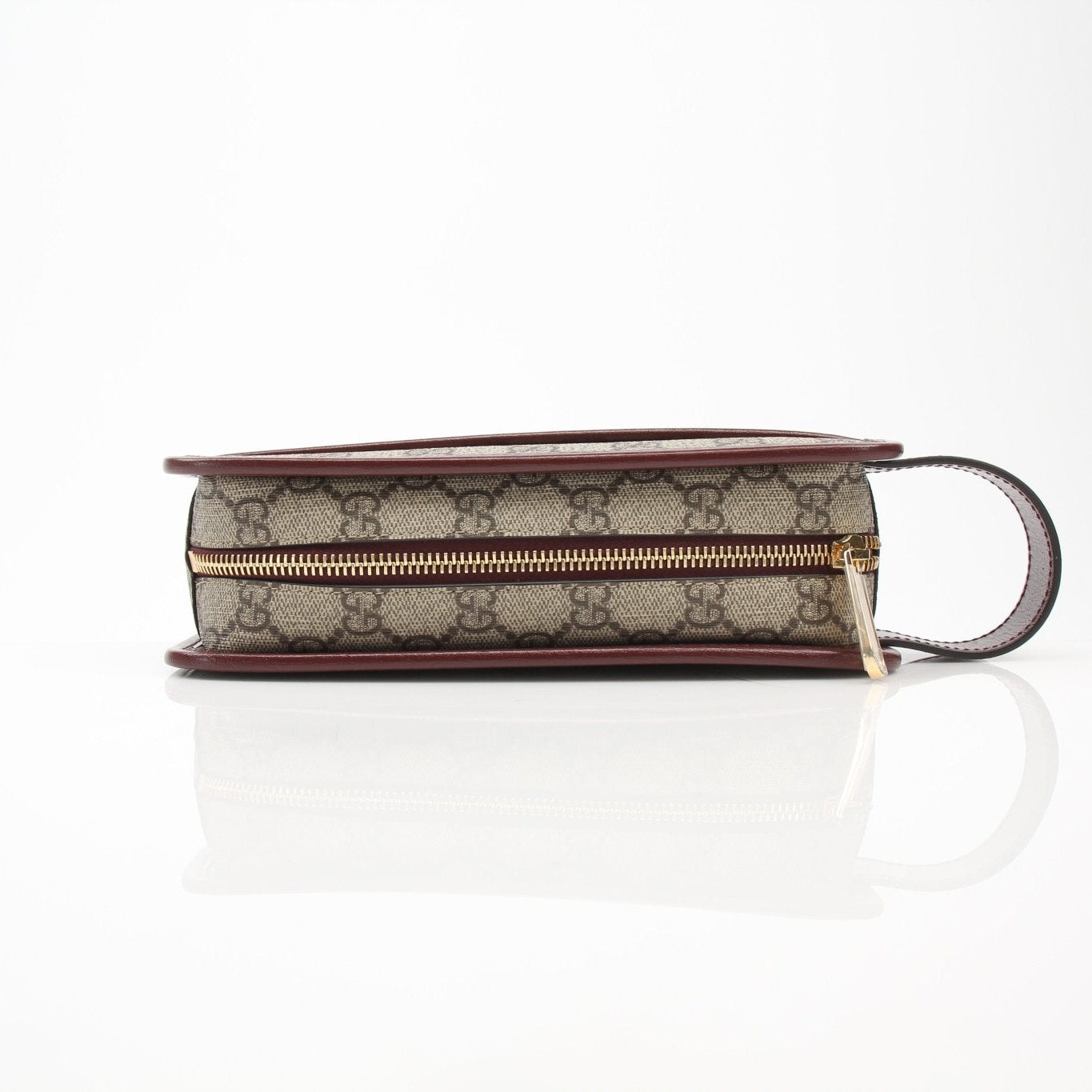 Gold & Beyond Gucci GG Supreme Dopp Kit pouch for travel bags, featuring a sleek design with signature monogram pattern.