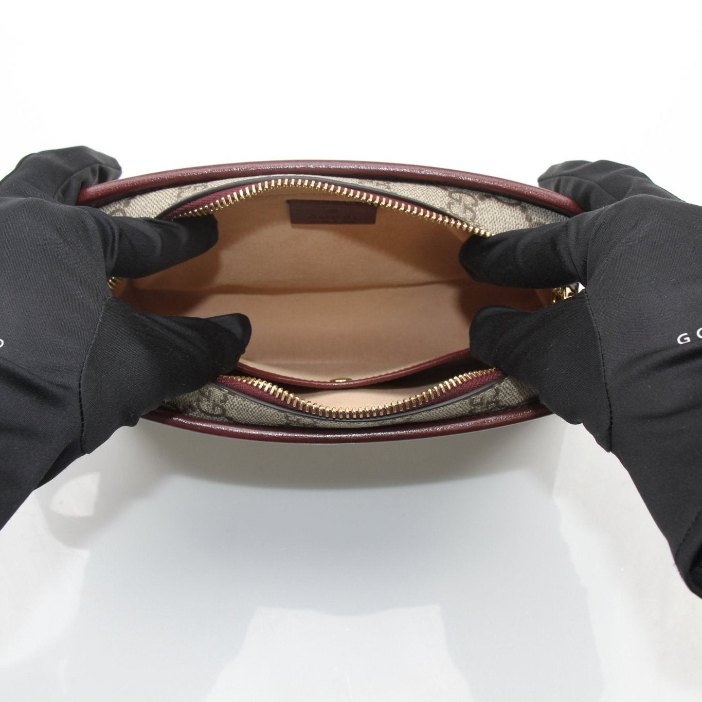 Gucci GG Supreme Dopp Kit pouch from Gold & Beyond, a stylish travel bag with signature monogram pattern and leather accents.