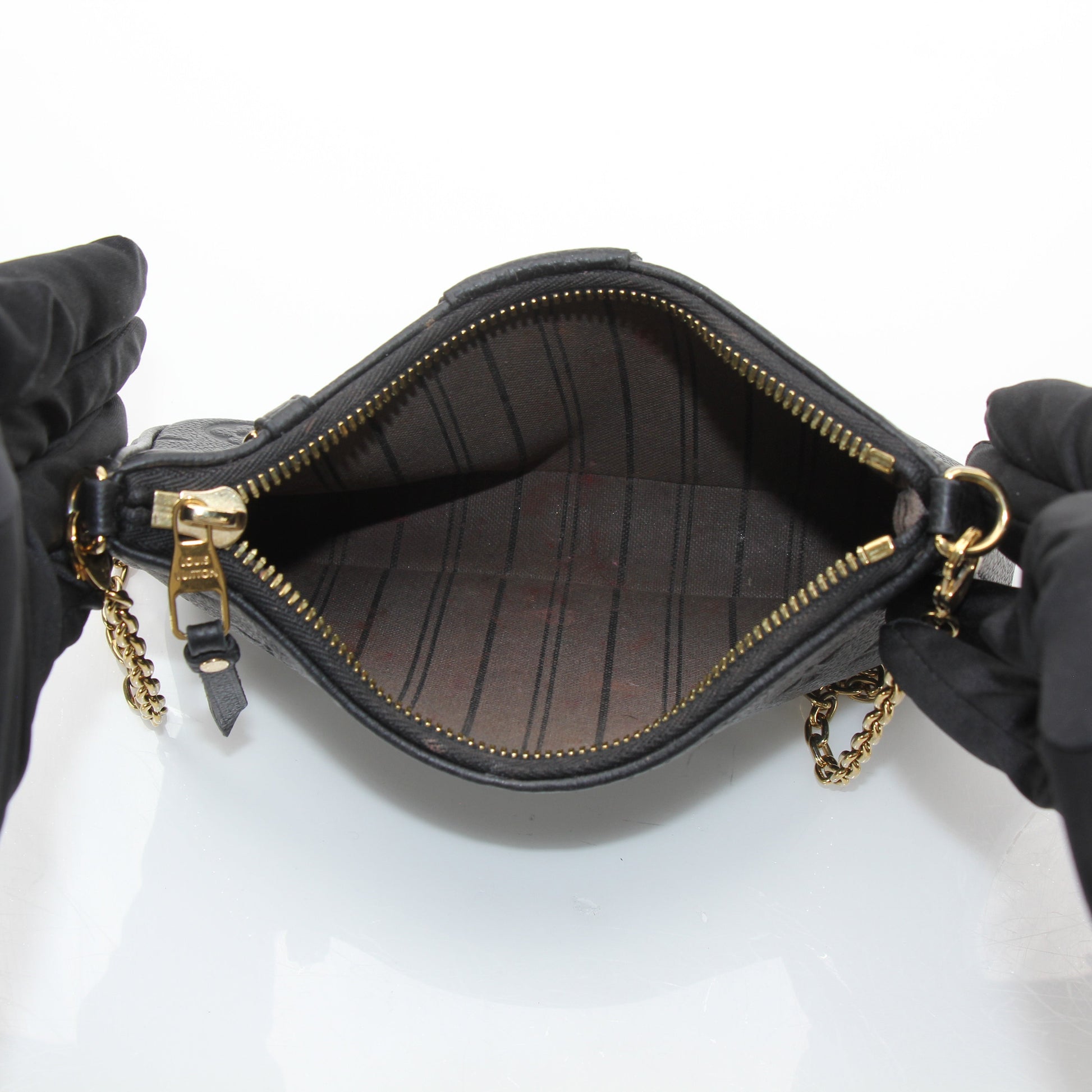 Louis Vuitton black Easy Pouch handbag on strap with gold accents, stylish accessory with sleek design and compact size.