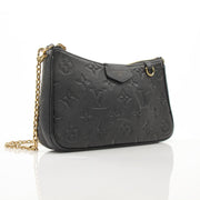 Louis Vuitton black Easy Pouch handbag on strap with gold accents, stylish accessory with sleek design.