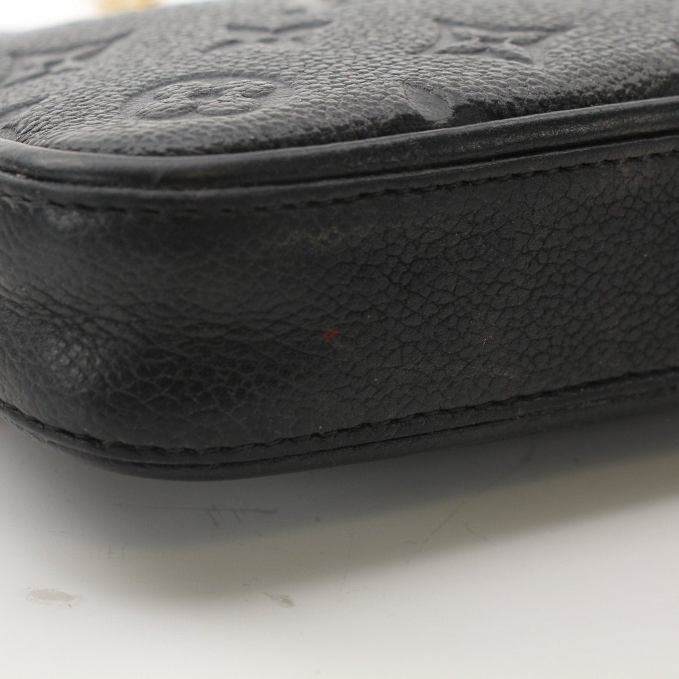 Louis Vuitton Black Easy Pouch handbag with strap, featuring sleek design and gold accents, shown in a close-up image.
