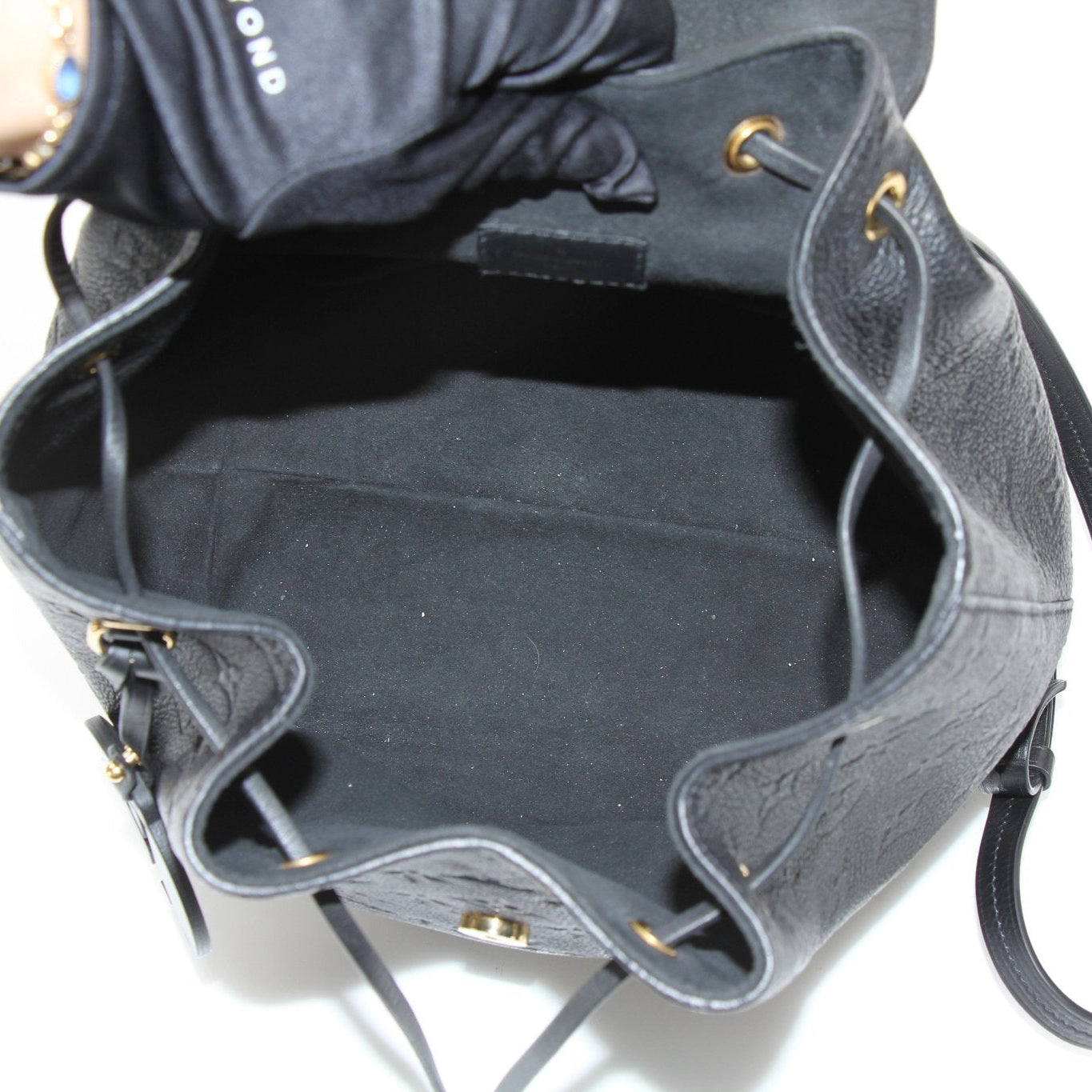 Gold & Beyond Louis Vuitton Mountsouris backpack, stylish travel bag with leather accents and spacious interior, ideal for travel.