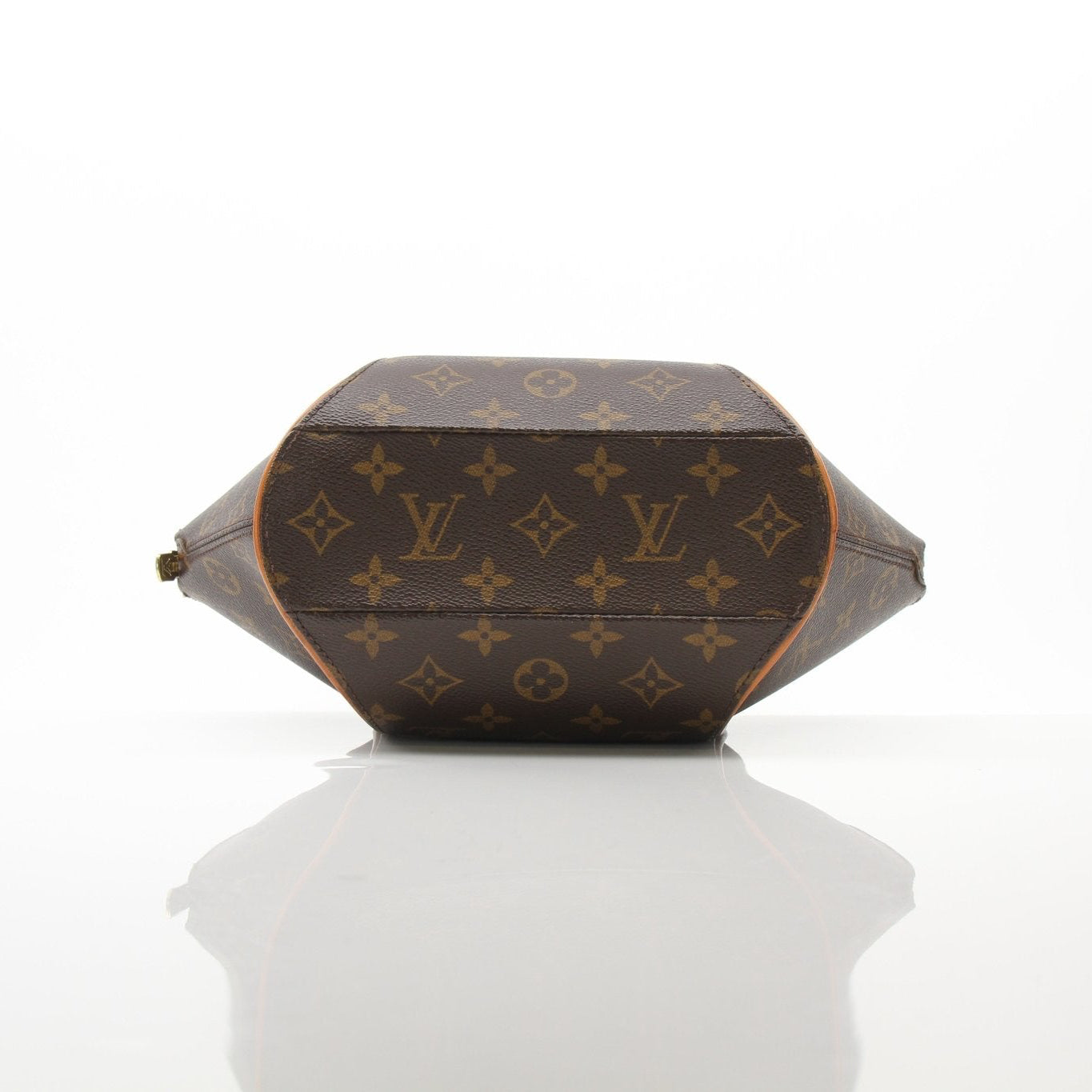 Louis Vuitton Ellipse PM top handle handbag with gold hardware and structured design, displayed in a natural setting.