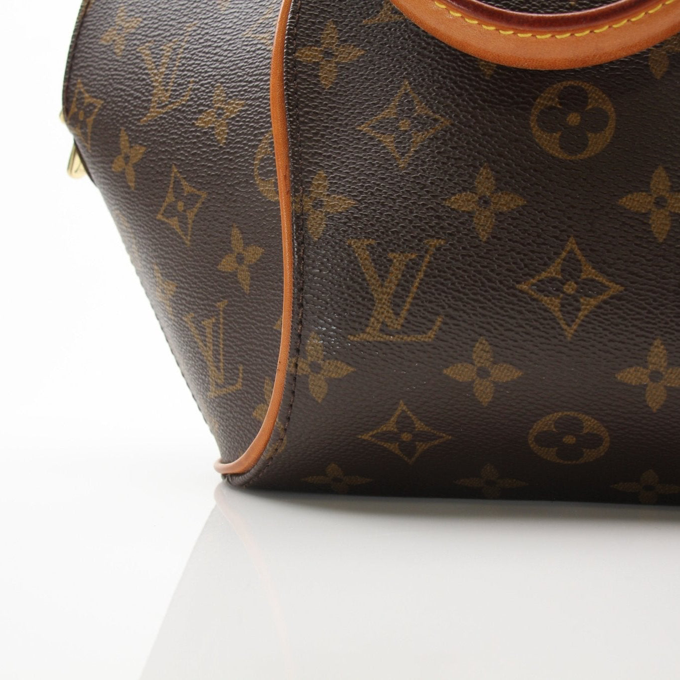 Louis Vuitton Ellipse PM top handle handbag with gold hardware and structured design, displayed on a plain background.
