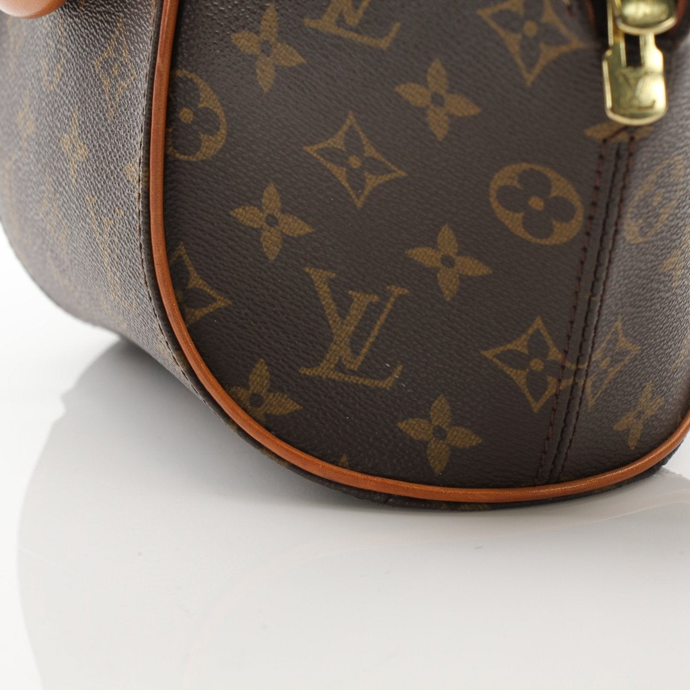 Louis Vuitton Ellipse PM top handle handbag with gold hardware and structured design, showcasing luxury leather craftsmanship.